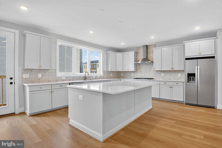 The main level features a bright, open design with a spacious great room, dining area and a rear kitchen. The chef-inspired kitchen showcases an expansive island with Calacatta Gold quartz countertops, Brellin Frost cabinets, stainless steel appliances, and gold hardware. Upstairs, the primary suite offers a large walk-in closet and a spa-style bath with quartz countertops. Two additional bedrooms, a full bath, and a conveniently located laundry room complete the second floor. The finished lower level adds extra living space with a bedroom, full bath, and a generous rec room.