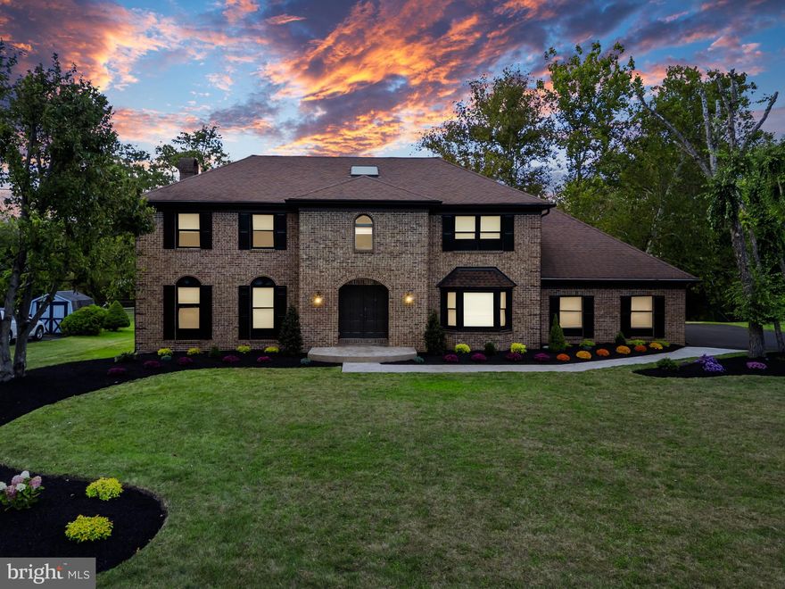 Experience timeless sophistication in this immaculate 5-bedroom, 3.5-bath brick colonial, ideally situated at 1404 Cinnamon Circle on a peaceful cul-de-sac in the heart of Upper Dublin Township. Framed by mature trees and enhanced by meticulous new landscaping, this residence seamlessly blends classic architecture with modern farmhouse charm. Step inside to discover 3,870 square feet of beautifully reimagined living space, where every detail has been thoughtfully curated. The grand foyer welcomes you with 5-inch solid oak hardwood floors, intricate millwork, and modern oval metal balusters, setting the tone for the craftsmanship found throughout. To the right, the formal dining room exudes understated elegance with a contemporary chandelier, floating built-ins topped with live-edge wood, and matching live-edge wine displays—a perfect setting for intimate dinners and festive gatherings.
The chef’s kitchen and breakfast area are a true centerpiece of the home, masterfully designed for both functionality and style. Highlights include custom two-tone 42-inch cabinetry, a pantry with a barn-door slider, abundant built-ins, and a generous central island crowned with white quartz countertops and a dramatic waterfall edge. Premium Samsung appliances, including a sleek canopy hood, complete this impressive culinary space. Adjacent to the kitchen, a mudroom with a custom-built boot bench leads to a fully appointed laundry room, finished with elegant tilework. The family room offers a warm and inviting retreat, anchored by a wood-burning fireplace and enriched with shiplap walls, a coffered ceiling, and contrasting navy built-in cabinetry. A sliding door opens to a sprawling Trex deck, ideal for entertaining, with breathtaking views of the expansive backyard. The main level also features a private guest suite with a beautifully appointed full bath—perfect for visitors or multigenerational living. Ascend the staircase, illuminated by a dramatic skylight, to the second floor, where you’ll find a hall bath with heated floors, a double vanity with stone countertops, and a tub-shower combination. Each bedroom is generously proportioned and filled with natural light. The primary suite is a sanctuary unto itself, featuring a private study/den, multiple closets—including a coat closet, shoe closet, and walk-in—a tray ceiling with inlaid LED lighting, and an electric fireplace. A wet bar with a beverage cooler adds a touch of luxury. The spa-inspired primary bathroom is simply exquisite, showcasing imported tile, heated floors, a freestanding soaking tub, a double stone vanity, and a glass-enclosed shower with a bench. The lower level offers a versatile open space with a walk-up to the backyard, ready to be transformed into an entertainment hub, home gym, or personal retreat. Additional highlights include a newer HVAC system, a brand-new hot water heater, and an enviable location just minutes from premier shopping and dining destinations such as The Promenade, Willow Grove Park Mall, Plymouth Meeting Mall, and King of Prussia Mall. This extraordinary residence is a rare offering, combining timeless elegance, thoughtful design, and modern luxury. Don’t miss your chance to call this exceptional property home.
