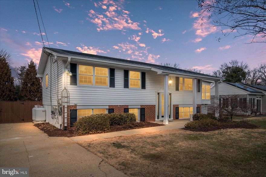 Welcome to 100 Carroll Drive, a fully remodeled four-bedroom, two-bath split foyer in the desirable and sought-after waterfront community of Hillsmere Shores in Annapolis. The upper level features a completely renovated open-concept layout with a stunning kitchen showcasing new cabinetry, new appliances, countertops, and luxury vinyl flooring throughout, flowing seamlessly into the dining and living areas—perfect for everyday living and entertaining. Just off the living room, enjoy an enclosed deck that adds extra flexible space and a great place to relax or entertain. This level also includes three spacious bedrooms and an updated full bathroom. Downstairs, the home continues to impress with tiled flooring throughout, heated floors, and a large primary suite with a private full bathroom, plus walkout access to an enclosed patio featuring a heated exercise pool or hot tub. Outside, the property offers a large cleared lot with beautiful landscaping, an irrigation system, and a shed for additional storage. Hillsmere Shores is known for its exceptional community amenities including a marina, multiple boat ramps and kayak launches, a beach, playground, and access to Quiet Waters Park, with the Key School conveniently located right across the street. An electric vehicle charger is also included, adding even more value and convenience—this move-in ready home is a rare opportunity to enjoy a renovated property and an unmatched Annapolis lifestyle.