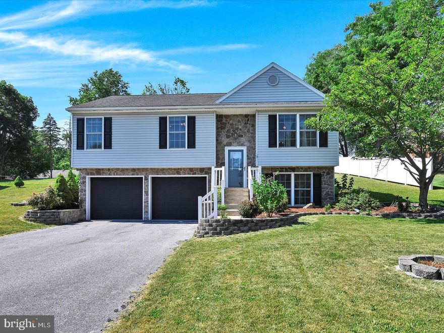 Nestled in the serene North Lebanon Township, this exquisite bi-level home offers a perfect blend of luxury and comfort. Built in 2005, the property showcases a stunning exterior with elegant stone and vinyl siding, complemented by beautifully crafted stone retaining walls that enhance its curb appeal. Step inside to discover a thoughtfully designed interior. The kitchen is equipped with a built-in microwave, electric oven/range, and a sleek dishwasher, ensuring culinary delights are just a step away. The family room, conveniently located off the kitchen, creates a warm atmosphere for relaxation and gatherings. This residence boasts three spacious bedrooms and two full bathrooms, all well maintained. The fully finished daylight lower level offers additional living space, complete with garage access. Outside, the expansive 0.41-acre lot features a beautifully landscaped front yard and a large deck, ideal for outdoor entertaining or enjoying peaceful evenings. With an attached two-car garage and a private asphalt driveway, convenience is at your fingertips. Experience the exclusive lifestyle this remarkable home offers. Continue to rent it out for income or make it yours. Schedule your showing today.