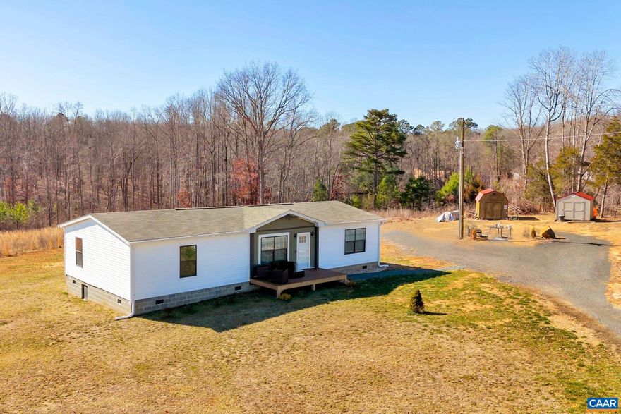 6.485 acres and an almost new, adorable one level home await its new owners to create a farmette or your own personal playground! Tucked away from the road, you'll find that much of the land is already cleared, with mature trees lining the perimeter for your privacy.  The home is situated along the western boarder of the property featuring a creek in the woods to the rear.  A large front porch welcomes you and inside you'll love the light filled, open floorplan. A large living room is open to the dining area and kitchen with breakfast bar island and huge farmhouse sink. Frigidaire appliances are all included - flat top range, side by side refrigerator, dishwasher and microwave. Adjacent to the kitchen is a huge pantry and laundry room with LG washer/dryer. The primary bedroom features a walk in closet, plus a fantastic bathroom with double vanity, freestanding tub and a 4 foot tiled shower with seat. Two additional bedrooms plus another full bathroom complete the inside. A rear deck, and 2 storage sheds complete the home. 5 minutes to local winery, 14 miles to Downtown Charlottesville.,White Cabinets