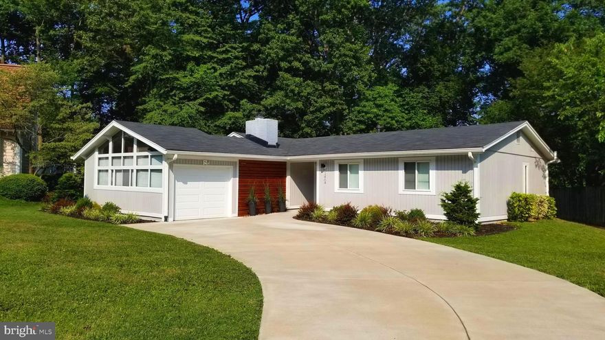 What an exceptional one level living property in Lake Ridge.  The owners have transformed this home into a modern and contemporary home with 3 bedrooms and 2 baths, and NO HOA.  Home has been fully renovated top and bottom, great craftsmanship and details throughout.  A large and brand new driveway and beautiful landscaping greet you as you arrive to this lovely home.    You will love the look of the custom exterior wooden wall combined with  the vertical vinyl siding that give the house a modern contemporary look. You can easily entertain in the beautiful gourmet kitchen that has a large island with quartz counter top and stainless steel appliances. Stone back splash, pendant and recessed lighting and do not to forget the tall ceilings, make this kitchen very bright and open. Dining room with big windows overlooking the backyard is next to the kitchen, making it very easy to serve meals any time of the day. Family room has a wood burning fireplace and tall ceilings overlooking the breezeway.  Good sized master bedroom has a walk in closet and it's own master bathroom. 2 additional good size bedrooms as well with a guest bath just down the hall.  You can relax in the breezeway that offers space for your outdoor sitting and is large enough for your guests and the grill.  Property is very close to commuter lot, short drive to I-95 or Rte-1, shopping and restaurants.