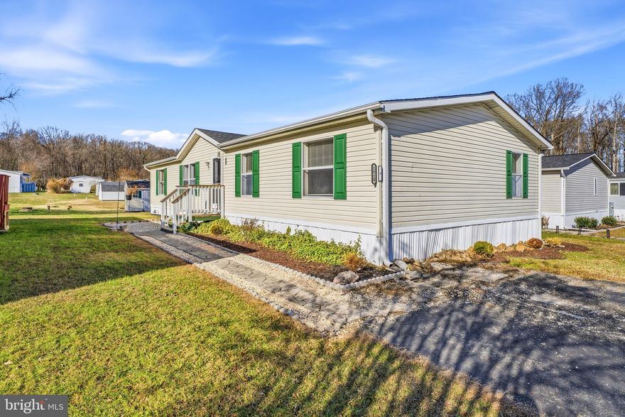 This stunning 2001 doublewide offers 1,980 sq. ft. of bright, open living space and sits on a large, level lot—perfect for gatherings and outdoor enjoyment. A newly installed roof and a custom 8' x 12' matching storage shed add tremendous value and convenience.
Inside, the home has been thoughtfully updated with new high-quality flooring, fresh paint, custom moldings, and upgraded systems including a new HVAC, hot water heater, and smoke detectors. The spacious open floor plan creates a warm, inviting flow throughout.
You’ll love the custom-designed kitchen, featuring an island with sink and bar seating, tile backsplash, newer appliances, and a custom pantry with added storage. Adjacent is a roomy dining area for effortless entertaining. A convenient laundry/mudroom includes cabinets and a washer and dryer.
With three generous bedrooms plus a large bonus room, this home easily accommodates a 4th bedroom, office, or family room. The private primary suite sits opposite the guest rooms and includes an oversized walk-in closet and spacious ensuite bath with a relaxing soaking tub.
Outdoor highlights include front and rear porches, tasteful landscaping, and a welcoming walkway.
Located in Bush River Manor, a quiet, friendly community nestled beside a wildlife estuary, residents enjoy wooded walking trails, a fishing spot, and peaceful waterview strolls. Experience low-maintenance, single-level living at its finest.
Park approval required