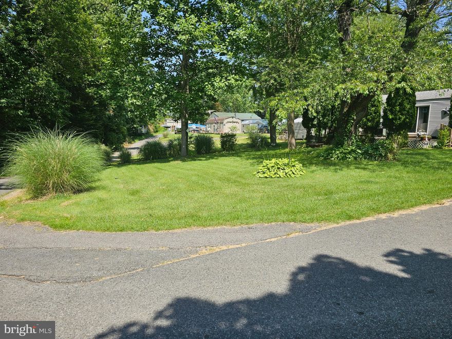 Large Corner lot with your camper to make this site complete. Gated water oriented community with boat ramp, lake, two ponds, and pools. Located in Indian Acres Campground which is limited to 150 days a year no more than 100 consecutive days (not a full time residence). Open year round as well as the convenience stations. A great place to kick back and relax. Seasonal activities as well.