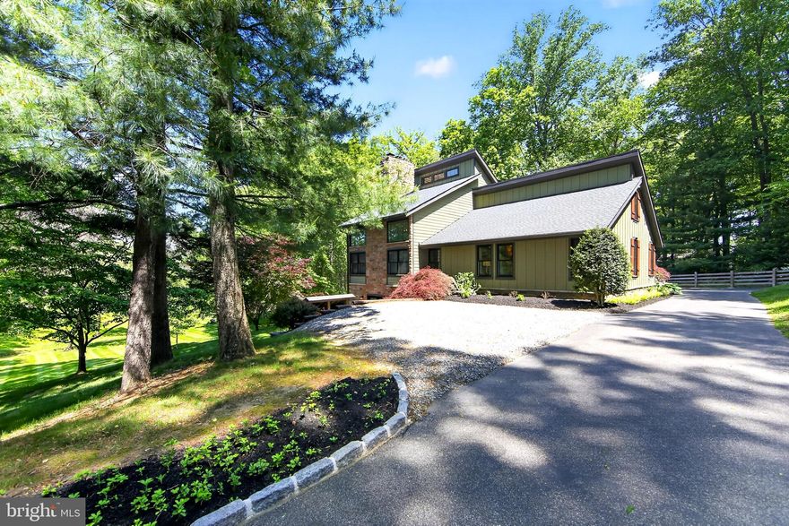 A distinctive contemporary home in desirable Thornbury Township, Delaware County, offering top-rated schools, low taxes (NO TOWNSHIP TAX-$7115 TOTAL), and an exceptional West Chester location. On over three beautifully maintained acres, this property delivers outstanding value in a highly sought-after area. Set on a scenic blend of open meadow and wooded privacy, this 4-bedroom, 2-bath home offers the ideal balance of luxury, technology, and everyday comfort just minutes from West Chester and Media, with convenient access to Philadelphia and the International Airport.

Thoughtfully updated throughout, the home has undergone extensive exterior and mechanical improvements within the last four years.  Included are new insulation, siding, windows, roof, gutters, flashing, a 4-zoned Geo-thermal furnace, and tankless water heater (2025) providing lasting efficiency and peace of mind. Inside, natural wood flooring flows throughout the main living areas, complementing a versatile layout designed for modern living. The expansive family room serves as the heart of the home, featuring soaring ceilings, striking designer light fixtures, and a dramatic double sized fireplace that creates a bold architectural focal point. Lutron smart wood blinds automatically adjust with the sun’s intensity and direction, enhancing both comfort and efficiency while maintaining a refined, modern aesthetic. Three bedrooms are located on the main level, including one currently used as a sophisticated home office featuring wall-to-wall and floor-to-ceiling custom built-ins and a wet bar with wine refrigerator.

The second level is dedicated to a private primary suite retreat, featuring a spacious bedroom with a fireplace (provisioned for propane), automated Lutron smart blinds that adjust with sunlight, and a conveniently located laundry area. The renovated spa-inspired primary bath showcases a floating double vanity and mirrors programmable for gradual illumination, creating a calm and elevated daily experience.

Again, set on over three beautifully maintained acres, the grounds offer exceptional privacy and tranquility, with rolling lawn, mature landscaping, a 3-tiered composite deck stepping down to paver patio ideal for fire pit. Rounding out the home is an unfinished walk-out basement with french doors onto level patio.Combining acreage, privacy, smart-home functionality, and low-maintenance living in a premier West Chester location, this is a truly unique offering in today’s market.