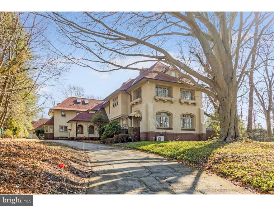 Built in 1900 and nestled on a 1 acre corner lot in most desirable Merion Station, this stately and timeless mansion boasts outstanding craftsmanship, exquisite mill work, the charm of yesteryear and today's amenities. You are welcomed into an elegant entrance hall, with gorgeous wood paneling, marble floors, fireplace, and 3 large sets of French doors opening unto the front southern terrace. To your right is a spacious living room, with f/p, and French door access to the terrace, as well as the 4-season sunroom. To the left of the entrance hall, the original sitting room now features a large closet, a cozy window bench, powder room, and small butler area complete with sink, storage, display shelves and pass through to the kitchen. Make your way up a couple of steps through the archway flanked by exquisitely carved wood columns to a most elegant formal dinning room, with marble faced f/p, and lots of south facing windows, and large French door to the sunroom/den which serves as an informal family space with access to the outdoor patio. A bright large butler's pantry, with plenty of cabinetry, display area, counter space, sink, oven, connects the dining room to the extra-large gourmet kitchen featuring radiant heated tile floor, and 2 of everything: stoves, fridges, microwaves, sinks, and dishwashers. There is plenty of counter space and a lovely breakfast area. Ascend the main staircase, passing on your right a handsome library with rich wood paneling,and custom bookshelves; the perfect place to curl up with a book or work. Located down the hallway, the master suite is its own little oasis.  The master bedroom is spacious with a large sun-room/sitting room, his and hers closets and a luxurious master bath. Two other large bedrooms each with full bath, laundry room, walk in linen closet and tons of storage space complete this floor. The third floor showcases 2 large bedrooms and 2 full baths, as well as a smaller bedroom, and a cedar closet. The lower level offers a large play/game/media room, a guest suite with access to the outside, and lots of additional storage. There is a detached 3 car over-sized garage/carriage house with an upper level apartment- an ideal home office or guest suite. Located in award winning Lower Merion School District, and near shopping, dining, places of worship and transportation.  There are 5 heating/cooling zones.