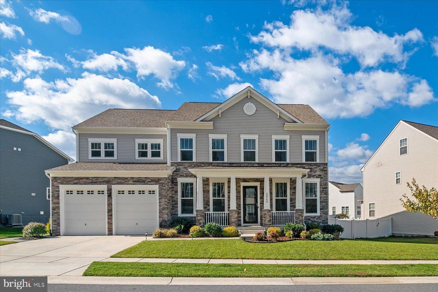 Breathtaking Breckenridge model by Stanley Martin Homes with  5-bedroom, 4.5-bath boasting 5,500 sq. ft. of luxury living in the sought-after Two Rivers community. Professionally curated design finishes throughout with over $100K in upgrades. The main level showcases 10-foot ceilings, a welcoming foyer that opens into a library/study, plus a versatile flex room, perfect for a formal sitting area. The open layout flows into the spacious open-concept great room, anchored by a cozy gas fireplace. The gourmet chef’s kitchen and heart of a home features a massive quartz island, high-end stainless steel appliances, gas cooktop, double ovens, 42” upgraded cabinets with crown molding, a stylish tile backsplash, and a walk-in pantry with prep station. The kitchen transitions seamlessly into both the morning/dining room and a bright breakfast area, creating a connected space ideal for entertaining and everyday living. A convenient mudroom, located just off the kitchen, provides smart storage and leads directly to the oversized 2-car garage. Upstairs, the Owner’s Suite offers an exquisite retreat with double-door entry, tray ceiling, abundant natural light, a relaxing sitting area, spa-inspired bath with soaking tub, dual vanity, oversized tiled walk-in shower, and two large walk-in closets. The laundry room is conveniently located just steps from the primary suite and three additional spacious bedrooms, one featuring a private ensuite, all with walk-in closets. The finished basement is perfect for entertainment and relaxation, featuring a large rec/game room, theatre room, 5th bedroom, and full bath—perfect for guests or multigenerational living. The backyard oasis is equally impressive with a screened-in covered porch with retractable sunshades, a composite deck, a beautiful hardscape patio, and vinyl privacy fencing— a perfect space for relaxation or gatherings. Skip the construction wait and “base model" pricing! 
Residents of Two Rivers enjoy resort-style amenities including the clubhouse, multiple pools, fitness center, tennis and sports courts, community gardens, parks, playgrounds, and miles of scenic trails. Centrally located in the Baltimore-Washington Corridor, this home offers easy commuting to DC, Baltimore, and Annapolis—just minutes from the Metro, MARC Train, BWI Airport, and major commuter routes.