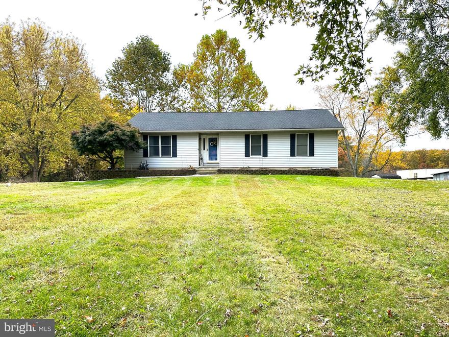 Welcome Home......well maintained rancher tucked away from the hustle and bustle...perfectly positioned on 1.56 acres/plenty of room to roam and backs to woods.....Main floor is 1440 sqft featuring 3 bedrooms and 2 full baths, beautiful renovated kitchen in 2021 with granite counter tops, breakfast bar, SS appliances and a spacious dining  area leading to back deck - great spot for relaxing, grilling and/or entertaining.  Entering the home you will see a cozy, yet sizable living room with lots of natural light and down the hall is a generous size primary bedroom with a stylish full bath/remodeled in 2023 - tile shower with glass door, tile flooring, new lighting & more .......In addition,  there is a full unfinished basement approx 1400+ sqft (walkout and inside connecting stairs).  New roof 2017, New SS appliances 2022, New water softener 2023... Property is out of town,  but convenient to restaurants & stores and just minutes to Delaware - tax free shopping.  Put this on your must see list!!