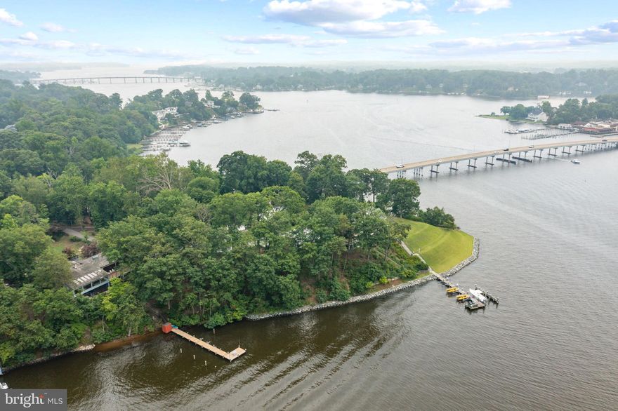 Welcome to 2916 Southwater Point Drive, Annapolis, Maryland. This remarkable waterfront residence presents an exquisite blend of elegance and serenity. Key features include a spacious gourmet kitchen with an open dining area boasting breathtaking views of the South River. The family room offers a stately wood-burning fireplace, soaring 10-foot ceilings, and expansive windows that provide a picturesque backdrop of the water. Step outside onto the large deck, a perfect spot to relax and soak in the beauty and privacy of the natural surroundings.

Situated on a generous 1.4+ acre lot, this property offers an outdoor paradise. The expansive field is ideal for sports and entertaining, while the hillside terraced garden beds, adorned with hand-carved statues, create a whimsical and magical ambiance. The yard also features a slide built into the hill, a swing set, and a climbing wall, providing endless fun for all ages.

Inside, the possibilities are endless. The lower level presents an indoor pool for year-round enjoyment, an additional bedroom with a steam shower, and a screened porch for peaceful relaxation. A short walk down the gentle path leads you to a private pier where you can access deep protected water and features a slip to accommodate a large powerboat. Equipped with electric and fresh water connections and a storage closet, the pier ensures a seamless boating experience.

Located close to shopping, dining, route 50, and all of the bars and restaurants along the South River.

Don't miss your chance to own this extraordinary waterfront retreat in the coveted Southwater Point community. Embrace the beauty of Annapolis living and create lasting memories in this exceptional home.

NOTICE: According to waterwayguide.com the Riva Bridge is:
Lat / Lon: N 38° 57.374' / W 076° 34.408'
Bridge Type: Fixed
Vertical Clearance (Closed): 25.00 ft.
Horizontal Clearance: 50.00 ft.