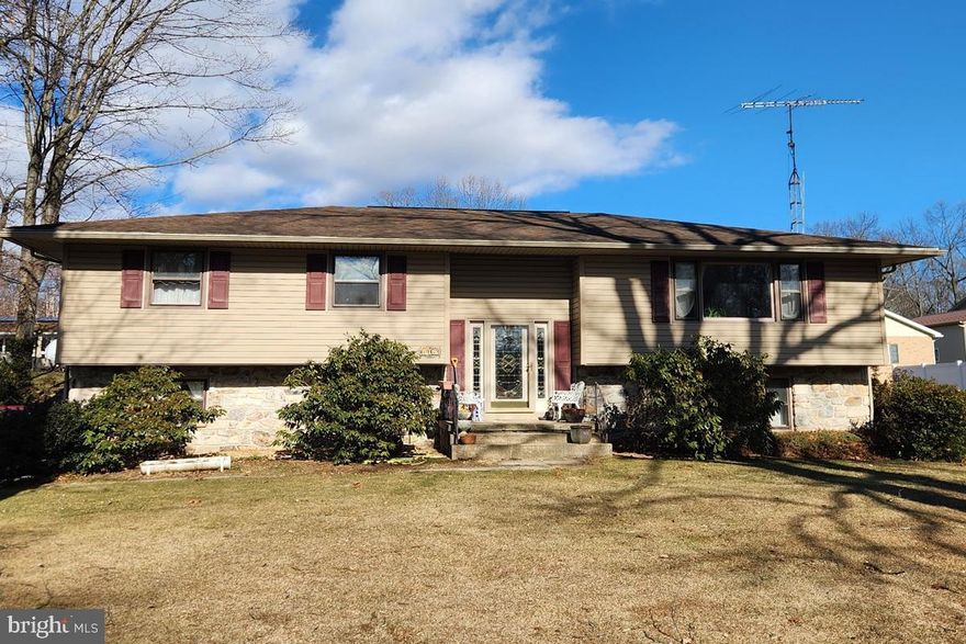 Welcome to 6463 Fairway Drive located in on a quaint street in a community surrounding Penn National Golf Course.  Sitting on .35 acres, this single family home has beautiful stone wrapping completely around the bottom of the home.  Upon entering the Split Foyer home, head upstairs to a spacious family room with larger windows letting in tons of light.  The kitchen has a stainless steel oven and LVP flooring.  The dinning room off the kitchen has plenty of room for a large table.  The primary bedroom has 2 closets and an attached en suite with a shower.  Two other bedrooms and a full bath complete the upper level.  Downstairs there is another family room with a beautiful stone fireplace with lots of natural light coming through.  A half bath, laundry space and a large 2 car garage complete the lower level.  The back yard has a large deck with plenty of room for a grill and table.