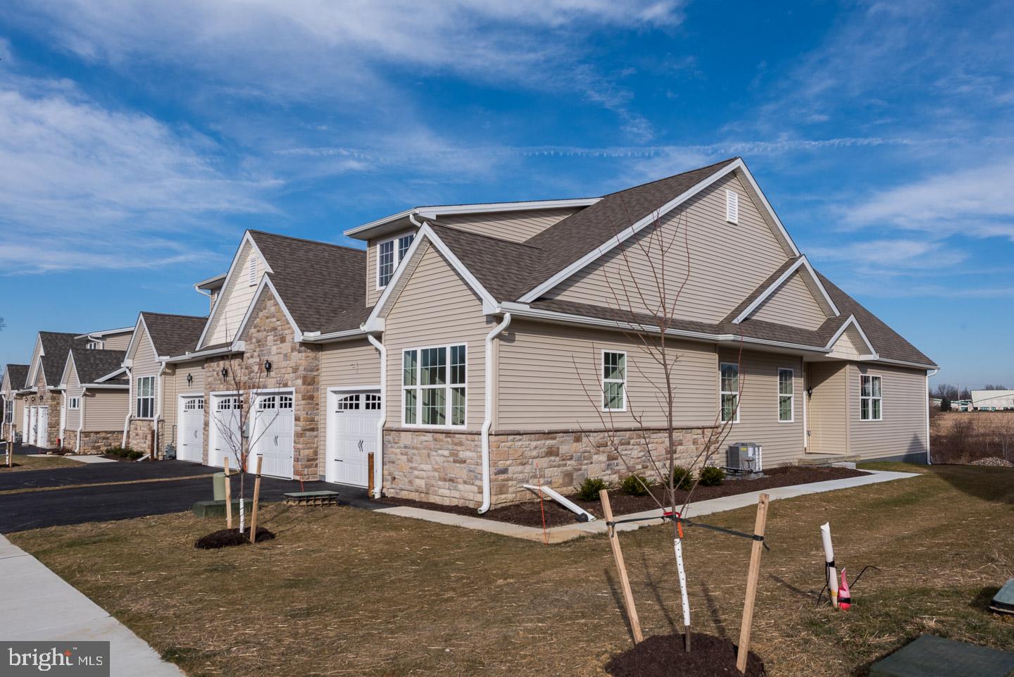 Immediate delivery! ONLY 6 REMAINING, DON'T MISS OUT! End Unit Carriage Home in Jennersville Farm with a two-car attached garage--Brand NEW with a versatile floorplan and gorgeous natural light throughout--within walking distance of shopping & restaurants! This 2 BR, 2 BA Williams model offers 1,871 square feet on one floor with generously-sized rooms, plenty of closet storage, and thoughtful UPGRADES throughout! The open Kitchen features gray-tone maple cabinetry by Century, Quartz Carrara countertops, stainless steel appliances, pantry with wide shelves, and island seating. Great Room with gas fireplace, crown molding, and patio access. Master suite with two closets including a walk-in plus a bright and spacious master bathroom with dual vanity. Oversized laundry room with utility tub. Upgraded carpeting in bedrooms. Our community is ideally located in close proximity to retail centers, medical offices, and major routes, and offers walking trails, fitness center, and plenty of social opportunities! Photos represent a previously built home which may reflect options/upgrades.