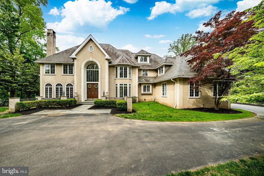 Welcome to 606 Longchamps, a truly spectacular 6-bedroom, 5 full and 2 half bath single family home nestled on a secluded, nearly one-acre wooded lot in the D'Orsey intimate enclave of estate homes community, within the top-rated Tredyffrin-Easttown School District. This remarkable property offers a perfect blend of elegance, comfort, and privacy—truly a showstopper! Approach the home via your long private driveway and enjoy the serene, wooded surroundings. Step inside the grand vaulted ceiling entryway, where the open floorplan flows effortlessly throughout the main level. To the left, the formal living room invites relaxation with its cozy fireplace, intricate crown molding, and abundant natural light streaming through large windows that frame your lush, green yard. To the right, the formal dining room impresses with elegant chair rail and crown molding, accented by a classic chandelier—perfect for hosting dinner parties. The heart of the home is the chef’s kitchen, featuring stainless steel appliances, a large center island with seating and a gas stovetop, and a dining area with panoramic views of the backyard. A built-in desk and cabinet system off the kitchen provides an ideal workspace with scenic views. Additional highlights include a spacious walk-in pantry and direct access to the wrap-around back deck, perfect for entertaining. The family room is a true showstopper, boasting vaulted ceilings, a dramatic floor-to-ceiling stone fireplace, and expansive windows that fill the space with light. The main level also includes a private office with built-in shelving and fireplace, two convenient half baths, and a laundry room for easy everyday living. Upstairs, the luxurious primary suite features plush carpeting, a large seating area, and a spa-like bathroom with dual vanities, built-in cabinets, a soaking tub, and a spacious walk-in shower. The ensuite primary walk-in closet completes this private retreat. Three additional bedrooms—some with private ensuites—offer comfort and style for family and guests. The top floor loft provides a versatile space for a play area or additional living area, complemented by a separate room currently used as a home gym and a full hall bathroom. The fully finished basement adds over 2,200 sq. ft. of living space, including another home office with built-ins, a large recreational area perfect for a pool table, an additional cozy living room with fireplace, and a private downstairs primary suite with ensuite bath and walk-in closet. Outside, your backyard oasis awaits with a wrap-around private deck offering panoramic views of your secluded wooded lot—ideal for summer gatherings and cookouts. Located on a quiet road, you can enjoy private neighborhood living while being close to parks, shopping, dining, and major roadways. 606 Longchamps is more than a home—it’s a lifestyle. This exceptional property seamlessly combines space, luxury, and privacy in one of Devon’s most desirable locations! Schedule your showing today!