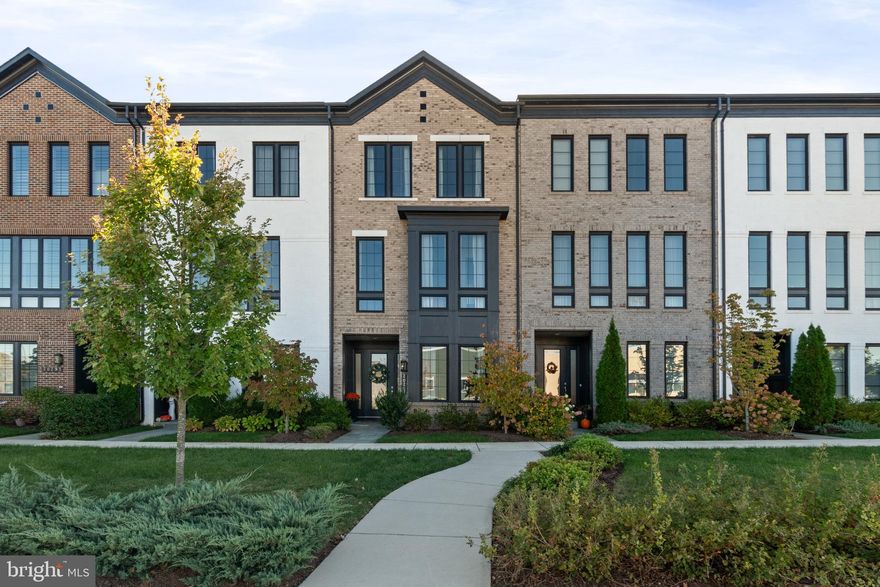 ****Open House Saturday, 11/1, 12-2pm. Nestled in the vibrant, walkable community of One Loudoun, this upscale and light-filled townhouse offers a perfect blend of modern living and comfort while the One Loudoun community provides the best of both urban amenities and the natural beauty of Loudoun County. A beautiful exterior with a stylish black two story bay window invites you and your guests inside to a hardwood foyer, an entry level bedroom/office and full bath. The large mudroom adds practicality and storage. High ceilings and an open floor plan on the main level create a spacious feel, connecting the kitchen, dining room and family room seamlessly while making the home ideal for both entertaining and everyday living. The gourmet kitchen boasts ample storage and an oversized bar, perfect for entertaining or a casual family dinner. The family room features a cozy fireplace, creating a warm ambiance for gatherings and leading out to a private, covered terrace for morning coffee or late night relaxation. On the third floor, the primary bedroom, large upgraded walk-in closet and sleek bath offer a spacious and serene retreat, while the spacious upper-floor laundry adds to the practicality of this well-designed layout. Outside again, enjoy sunny days at the community events, pool, playgrounds, farmers market, tennis courts, or walking paths. Then follow up the fun with an evening on the town at one of the many restaurants, the theatre, and the night life of One Loudoun and walk home again to beautiful 20287 Savin Hill. Welcome home!