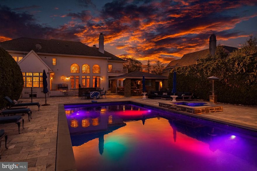 A Masterwork of Refined Living in Prestigious Wayne, PA. Set amid the storied Main Line, this exceptional residence embodies the very finest in East Coast luxury living. Positioned on nearly an acre in the coveted Whitegate enclave, the home offers an impressive 7,640 total square feet of meticulously curated interiors and world-class amenities—creating a sanctuary where sophistication, comfort, and architectural excellence converge.

From the moment you arrive, the home’s elevated design reveals itself. Custom Italian Bella Porta Miraquadra Series doors usher you into a world of craftsmanship and impeccable taste. At its heart lies a chef’s kitchen conceived for both culinary artistry and everyday elegance—showcasing executive-grade custom cabinetry, Silestone White Zeus countertops, and a full suite of Sub-Zero, Wolf, and Bosch appliances. A grand 1½-inch butcher-block island stands as the centerpiece, outfitted with a Rohl farmhouse sink, artisan faucets, ambient pendants, a statement chandelier, and luxe details such as an Insta-hot and filtered water system and pot filler. Mosaic glass tilework and custom seating complete this remarkable culinary environment.

Entertaining unfolds with ease in the gracious living and dining spaces, each enhanced by bespoke built-ins and designer window treatments. A richly appointed office provides an inspiring setting for work or reflection, while the sun-splashed conservatory offers a peaceful vantage point to take in the home’s serene surroundings. Three fireplaces—including one positioned poolside—infuse the home with warmth, ambiance, and architectural character.

The primary suite is a haven of pure indulgence. Custom wardrobe cabinetry, a tailored dressing table, and a private balcony overlooking the pool create an atmosphere of serene elegance. The spa-inspired ensuite bath boasts heated marble floors and a custom steam shower with multi-massage heads—an everyday retreat reminiscent of a boutique luxury spa. Secondary bedrooms continue the home’s elevated aesthetic with dual vanities and exquisitely finished custom showers.

For the automobile connoisseur or hobbyist, the property includes an attached 3-car garage paired with an additional two-story, 2-car structure. Outdoors, the estate reveals its resort-style amenities and a series of exquisite upgrades designed for luxurious living and exceptional entertaining. The expansive exterior patio is anchored by Silver Tumbled Travertine paver decking and elevated by Dolce Vita leathered marble counters. Artisanal Vihara Ehex Silk and Falling Star Sleek Ceylon wall tiles create a striking visual backdrop, while a GE Monogram grill and burner, custom built-in fireplace, and integrated pizza oven offer an unrivaled alfresco culinary experience. A sophisticated pool with retractable cover, a well-appointed pool house, and a handcrafted stone bar further enhance the outdoor oasis.

Completing the grounds is a private park complete with tennis and basketball courts, a playground, and manicured green space for recreation and relaxation. The heated granite cobblestone driveway adds both elegance and functionality, ensuring a grand approach in every season.

The lower level extends the home’s entertaining prowess with a custom bar—enhanced in 2020 with new appliances—a climate-controlled wine cellar, dedicated home gym, and an immersive theater room designed for cinematic experiences.

Offering five spacious bedrooms and six luxurious baths, this residence is the epitome of harmonious living. Additional comforts include central air, a stately fireplace, and a thoughtfully planned laundry suite.

1053 Whitegate Road stands as a statement of luxury, lifestyle, and legacy—an extraordinary opportunity to acquire one of Wayne’s most distinguished properties in the heart of the Main Line.