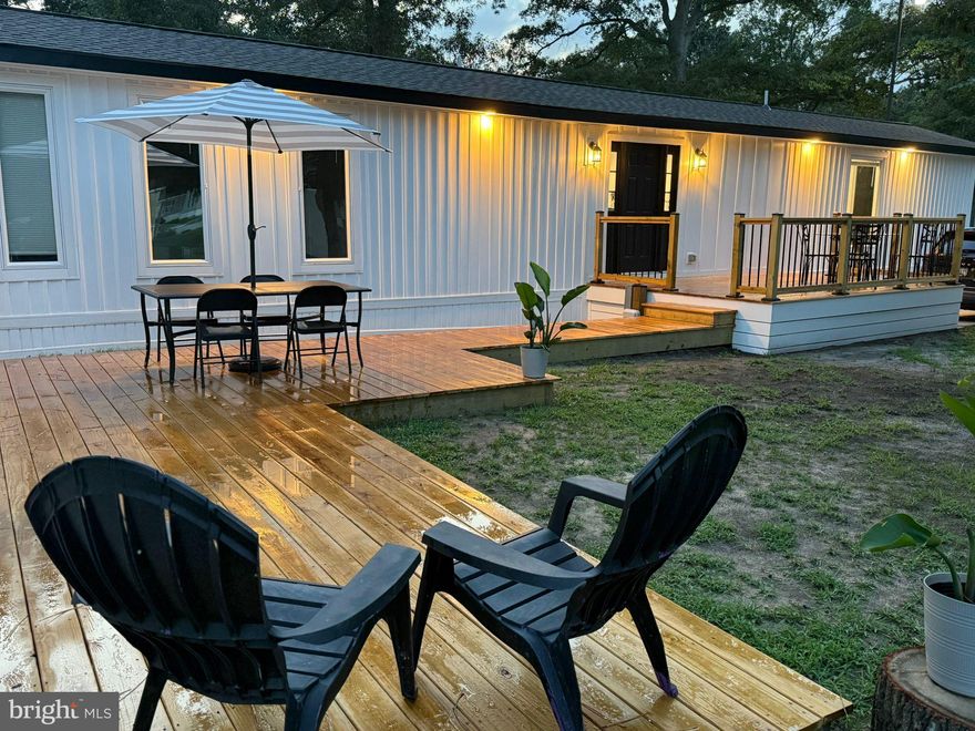 Motivated Sellers!! What a deal!!  Step into effortless style and smart design with this fully renovated (from the subfloor and studs on up), beautifully crafted mobile home. Perfect for modern living, this home offers a fresh, open-concept layout with sleek finishes and all the comforts of a traditional home—without the hefty price tag. Stainless steel appliances, chic cabinetry, and a breakfast bar perfect for entertaining or everyday meals.  Bright and airy open-plan living, dining, and kitchen space with large windows that bring in natural light. Enjoy the huge private deck or patio area—ideal for relaxing or grilling on summer evenings. 
Whether you're downsizing, just starting out, or looking for a low-maintenance lifestyle, this mobile home offers high-end living with unbeatable value. Move-in ready and located in a peaceful, well-maintained community—this is the stylish upgrade you’ve been waiting for!