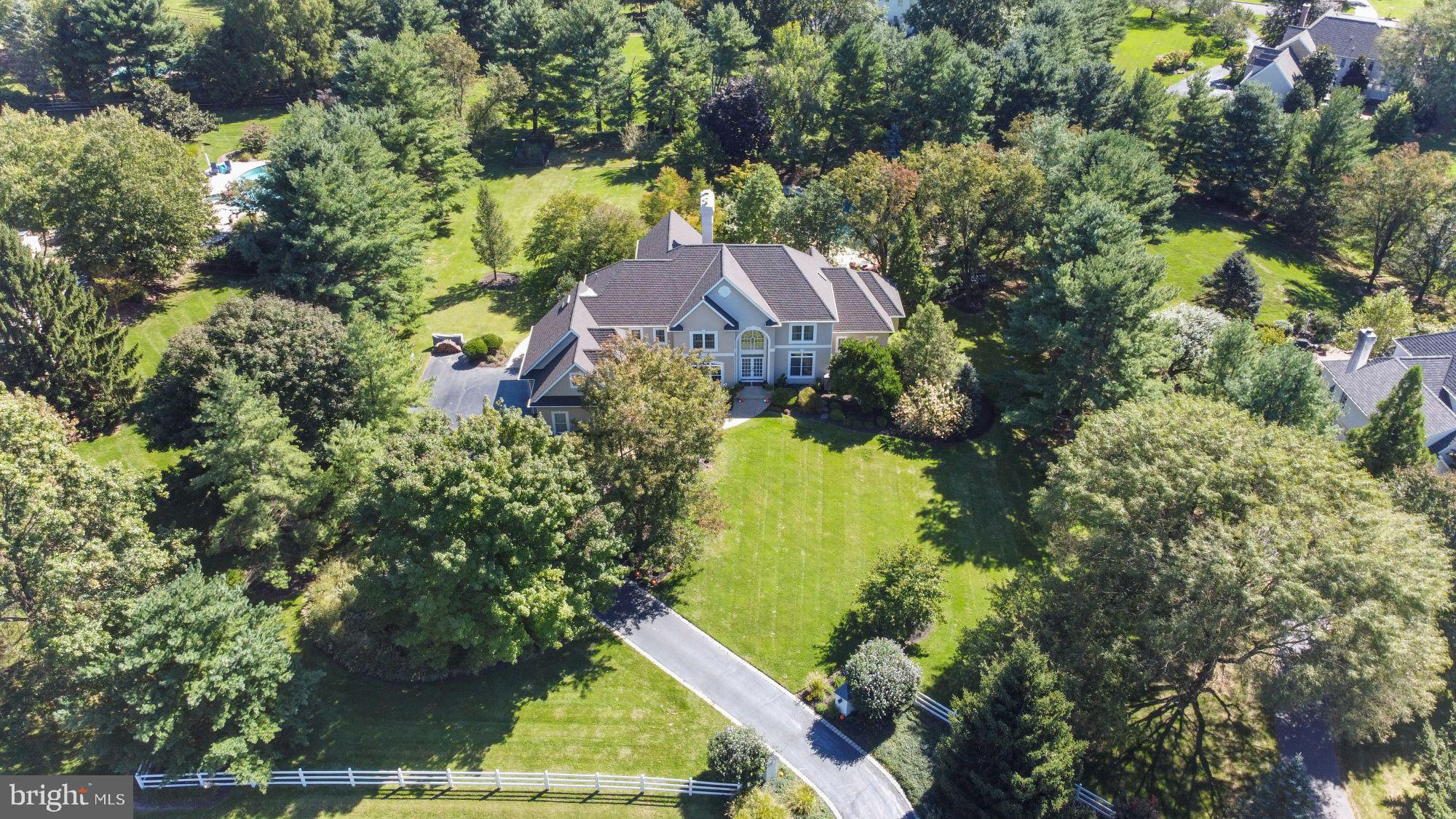 Welcome to 5 Weatherfield Drive in the highly desirable Weatherfield neighborhood of Upper Makefield Township. Exquisite European English country style with custom millwork and impeccable workmanship. Enter into the grand foyer and notice the high ceilings. The main level features a professional office, formal living room, formal dining room, family room, large kitchen with breakfast room, laundry room, master bedroom, half bathroom and access to the 3-car garage. The master suite is fantastic with a walk out to the backyard, large walk-in closet and full bathroom ensuite. The full bathroom has been modernized and features a large stall shower, nicely sized soaking tub and double sink vanity. The kitchen is out of this world being a chefs kitchen. All custom with high end appliances, upgraded countertops, beautiful cabinets with more than enough storage space and onyx! Off of the kitchen area is a large breakfast area. The main level flows nicely making for great entreating! You will love the massive windows in the family room and living room. Tons of natural light shines through. The second level features 4 bedrooms and 3 full bathrooms. The lower level is a finished basement with a large living area, dining room/pool table area, another bedroom with full bathroom ensuite, full kitchen and additional storage space. The exterior of the home is absolutely stunning with great curb appeal, 1.51 acres, large patio and pool! 5 Weatherfield Drive has so much to offer and will not last! Call to schedule a private showing today!
