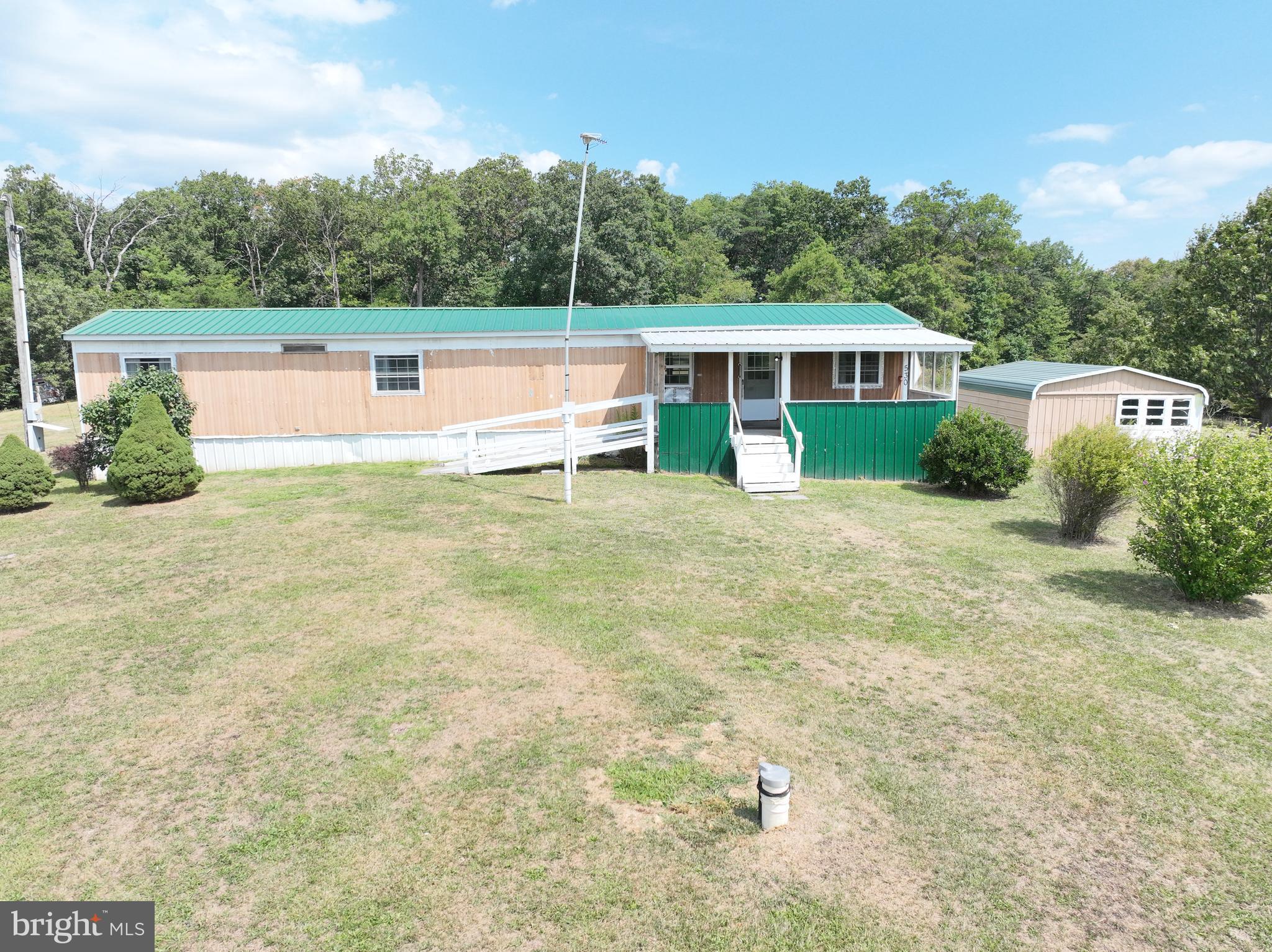 Don’t overlook the possibilities offered with this property! Yes, the home needs updating, however it is fully functional, solid and AFFORDABLE! New windows in 2015, new roof 2017, new well pump and pressure tank 2022, new furnace 2019!! This 5-acre lot is absolutely gorgeous and unrestricted! The land lays so nicely and is a perfect mix of open field and woods. The views are beautiful, you can see for miles and miles. Fruit trees adorn the property including plums and cherries! The potential here is endless! Bring your creative ideas and update the home, live in the mobile and build your dream home, put in a HUGE garden, pond, garage, or workshop! Come take a look, this one won’t last long!!