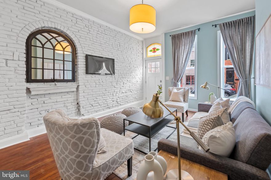 Situated only two short blocks from historic Federal Hill Park and  where you'll experience a front row seat to holiday fireworks and some of the best harbor and city views in Baltimore.  
This elegant 2 bedroom, 2.5 bathroom, mid 1860's rowhome has been thoughtfully renovated to retain it's historic footprint and features yet brings in the best of modern convenience. Gleaming original pine floors throughout all rooms except baths and kitchen. Original staircase placement of living and dining rooms provides grace and practicality for their use. Whitewashed brick walls lighten the space as do the ceiling height windows. 
The expansive kitchen sports ample white cabinetry and stone counter space. Gas stove with double oven will please serious chefs. An addition off the main level rear features a convenient laundry room and powder room combination. Multiple updates include water heater-2023, furnace-2023, AC-2024, front facing windows-2018. Primary bedroom has custom noise reduction inserts so you can sleep like a baby while living in the center of a thriving neighborhood of restaurants and entertainment.  This lovely home is  set apart from the others by it's character. It's not a cookie cutter house.