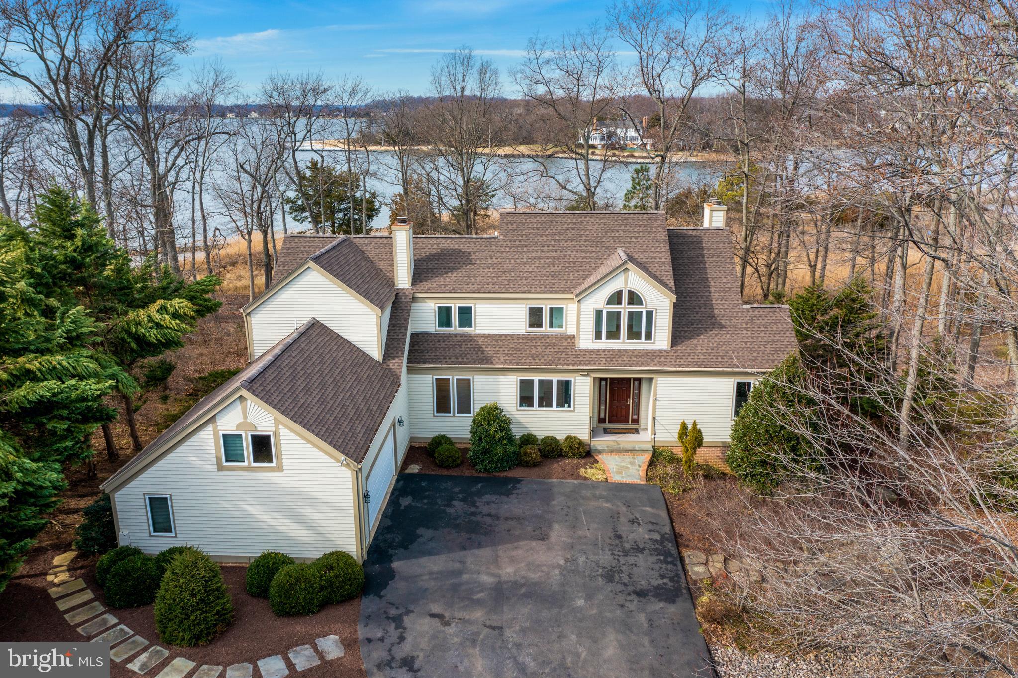Waterviews, spectacular sunsets and light filled contemporary with open floor plan and vaulted ceilings. This 4 Bedroom, 3 ½ bath home has a walk out finished lower level that abuts community open space steps and is 75 steps from the beach on Cherry Tree Cove. Mint, move in condition with new roof, appliances, kitchen countertops, sparkling refinished hardwood floors, new carpet and paint! Two car garage and in house generator.