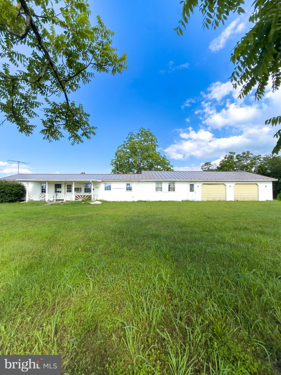 Welcome to 11101 Winchester Grade Rd, Berkeley Springs, WV—a spacious ranch-style home on 2.25 unrestricted acres offering peaceful country living with stunning easterly mountain views. This home features an expansive floor plan that provides extra flexibility. Step outside to a rear deck overlooking a big backyard—perfect for relaxing or entertaining. The oversized 2-car garage includes a built-in workshop, ideal for hobbies or storage. Located just a short drive from charming downtown Berkeley Springs, you'll enjoy nearby attractions like Berkeley Springs State Park, Cacapon State Park, and local shops and restaurants. With no HOA or restrictions, this property offers freedom and space in a tranquil setting—ideal for those seeking comfort, views, and room to grow.