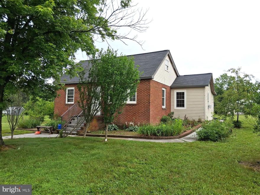 Great location. Public water. Brick and siding house with 1 and a half acres on 277/340 in Stephens City.  Price dropped $20,000 to sell..  Needs work and smells like cat.  Main level has 3 bedrooms, kitchen, dining room, living room and laundry.  Upstairs there is a 11x27 bonus room with built ins. Tenant is now gone; owner will clean house and remove remaining personal property.  Sold "AS IS".  Newer windows and doors.  Huge 1600+- sf garage/workshop behind house needs some work and was occupied by a landscaping business.  House has had some updates but could use more.  All of the county drain field records are in the docs along with cost to update.  Owner is in process of updating the septic as provided on the estimate.