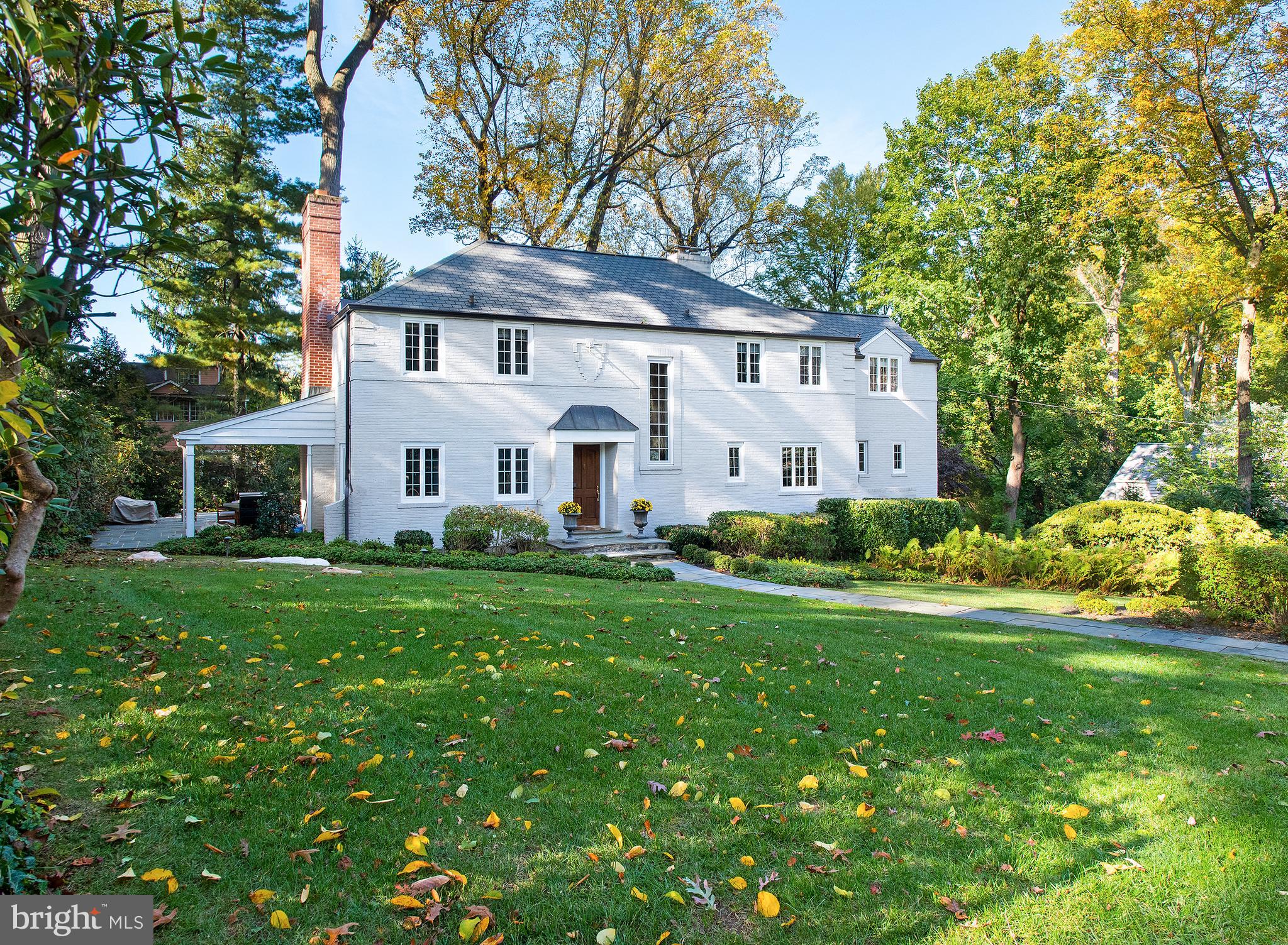 Home sweet home awaits at 310 Millbank Road, a beautiful custom French-inspired house on lushly landscaped grounds in a prime location! This distinctive Bryn Mawr gem with 4 bedrooms and 3.5 bathrooms is ideal for family living and entertaining for any occasion. Relax and host gatherings out on the spacious flagstone side patio, featuring a covered section with bead board ceiling and an uncovered area for enjoying the sun's rays. The kids and pets can play nearby on the generous grassy lawn with a customized lighting system and 3-zone sprinkler system. Inside is as inviting, with a sunny 2-story foyer and sleek curved hardwood staircase greeting you. Arched openings create an airy flow and lead to public rooms. A spacious light-filled living room with wood-burning fireplace opens to the flagstone terrace for seamless indoor-outdoor parties. Serve meals in the elegant dining room with built-ins and picture windows overlooking greenery. The gourmet kitchen affords easy serving and is finely appointed with generous wood cabinetry, premium Viking and Bosch appliances, wine fridge, dual sinks, extensive granite and wood counters for food prep, and striking black/white checkered floors. Nearby is a built-in workstation, open breakfast room, laundry room, and mudroom with an outside entrance. Completing the main level is a handsome wood-paneled office with built-ins and fireplace for working remotely, plus a convenient powder room. The turned staircase rises to the sleeping quarters featuring 4 sizable bedrooms and 3 full baths for the comfort of family and guests. The lovely master retreat indulges with an expansive outfitted dressing room, built-in closets, and stunning en-suite marble-clad bath. The second bedrooms is also en-suite, while additional bedrooms share a tiled full bath. The large day-lit lower level wows with its finished family room and wood-burning fireplace, perfect for casual get-togethers, game room for playing billiards, etc., along with a storage area with workshop, outside entrance, and attached 2-car garage. A home generator is convenient and adds peace of mind. This finely designed house is ready for you to move right into, situated on a quiet, scenic street in highly sought-after Northside Bryn Mawr!
