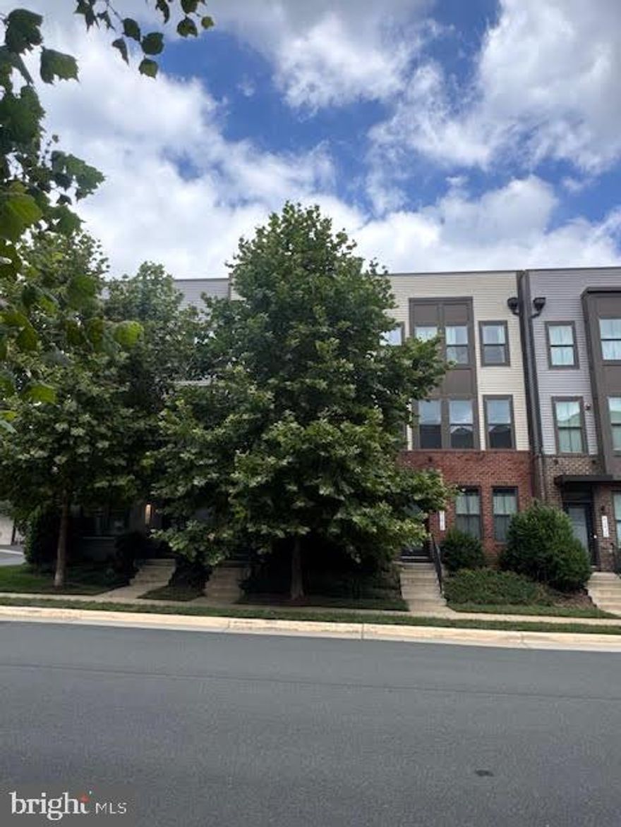 Prime Location! Just 1/4 mile from the Ashburn Metro! Live in the wonderful, open space of the suburbs but have quick and easy access to the City! This fantastic 4 bedroom, 4 full and 1 half bath Townhouse is over 4 levels including a balcony AND rooftop terrace! Upon entering, you will be greeted with beautiful hardwood flooring on the first floor including on the bedroom and full bath (owners transformed half bath to a full bath). The open concept main level features hardwood floors throughout, granite countertops, stainless steel appliances, backsplash, and cool two-tone cabinets (classy white kitchen cabinets with espresso cabinets on the center island). Enjoy some serenity on the balcony on this level. Climb to the third floor to see more hardwood flooring in the hallway along with 2 bedrooms and 2 full baths. The primary bathroom boasts nicely upgraded floor/shower tiles and dual vanities. The top fourth floor has another bedroom, full bath, open loft, and rooftop terrace with close views of the METRO! Additional perks include upgraded granite vanities in every bathroom, custom light fixtures, custom cabinets in both the primary and second bedroom closets, the extra long driveway to fit additional cars, and beautiful pull shades. Westmoore has great amenities such as 2 parks including Evermore Park (a gorgeous and expansive park with an amphitheatre, dog park, tot lots, and plenty of open space), a community pool, walking/jogging trails, fitness center, and a GREAT LOCATION that's so close to the Metro, the Dulles Greenway, Dulles Airport and everyday conveniences (shops/stores/restaurants at Loudoun Station and Broadlands Marketplace)! *HOME WILL BE DEEP CLEANED AND TOUCH UP PAINTED PRIOR TO NEW TENANT MOVE IN!