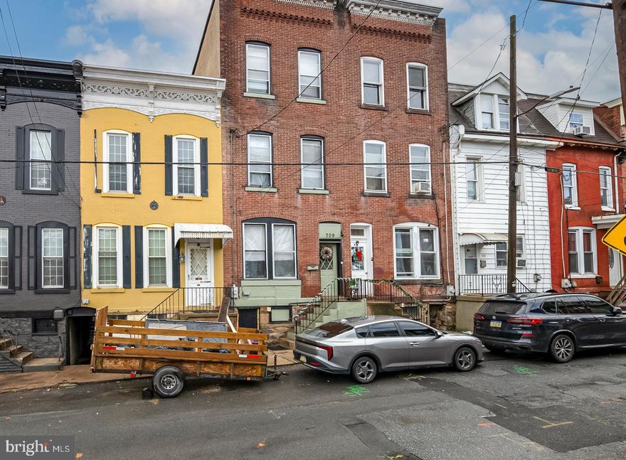 This spacious three-story brick home with six bedrooms and two and a half baths is full of classic charm with its high ceilings, beautiful natural woodwork, and hardwood floors throughout.  The main level includes a formal living room, dining room, and a kitchen with some granite countertops and a tiled floor.  There is also a convenient half bath on the main level.  The second floor has three nice-sized bedrooms and a full bath.  The third floor includes three additional bedrooms and a full bath, providing flexible living space that can be used for guests, a home office, a playroom, or extended living needs.  Several bedrooms have been freshly painted and have large windows that provide natural light.  A full basement with a laundry area with cabinets and storage space.  The property has economical gas heat that’s easy on the budget.  Off-street parking is available across the street for $40 per month.