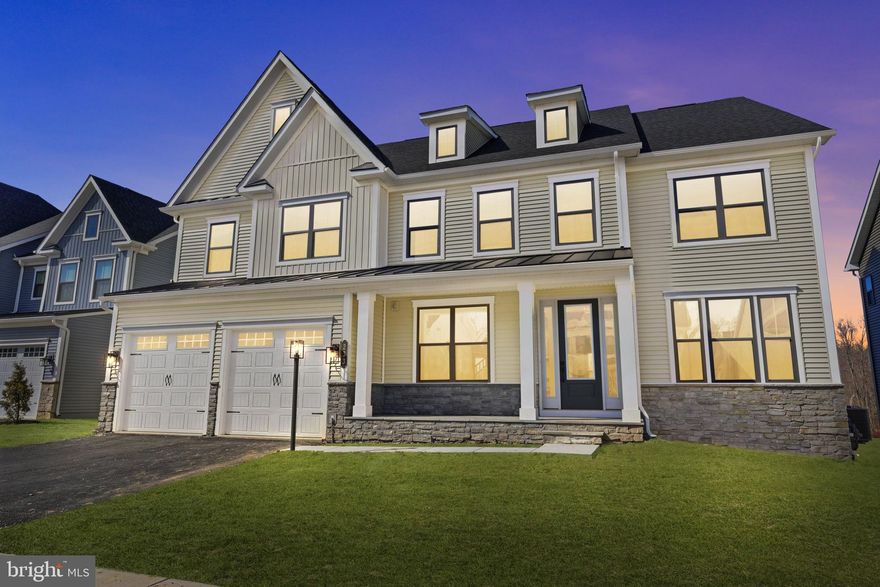 Welcome to refined luxury living in the heart of Exton—perfectly positioned on a premium homesite backing to open space and ready for immediate move-in.

Ideally situated just minutes from Exton Town Center, this exceptional residence offers the ideal balance of elegance, convenience, and community. Enjoy effortless access to premier shopping, dining, and everyday amenities while residing within the highly regarded West Chester Area School District—one of the region’s most sought-after locations for both lifestyle and long-term value.

Designed for both sophisticated entertaining and comfortable everyday living, this stunning Santorini residence showcases thoughtful architecture, expansive spaces, and timeless finishes throughout.
Step inside the grand foyer where the home unfolds with intention and elegance. A formal dining room welcomes gatherings and celebrations, while an adjoining flexible living space provides the perfect setting for a private office, library, or sitting room.

At the heart of the home, a chef-inspired gourmet kitchen features an oversized island and seamless flow into the expansive two-story family room and sunlit dining area. Here, a dramatic wall of windows fills the space with natural light while a breathtaking floor-to-ceiling stone gas fireplace creates a striking focal point and warm gathering place for family and guests alike.

The open-concept design effortlessly connects the home’s living spaces, creating a setting ideal for both intimate evenings and large-scale entertaining.

A private first-floor bedroom suite offers exceptional versatility—perfect for guests, multigenerational living, or extended stays.

Upstairs, three generously sized bedrooms each feature walk-in closets and private ensuite baths, offering comfort and privacy for family and visitors alike. The owner’s suite & sitting room is a true sanctuary, highlighted by two oversized walk-in closets and a spa-inspired bath with dual vanities designed for both luxury and relaxation.

Outdoor living is equally inviting. A covered porch with stone fireplace overlooks peaceful community open space, providing a tranquil backdrop for year-round gatherings, morning coffee, or quiet evenings under the stars.

The finished walk-up lower level expands the home’s possibilities even further. Complete with a private bedroom and full bath, the space is ideal for guests, an au pair suite, or extended family. The expansive layout easily accommodates a media lounge, recreation room, fitness studio, or additional entertaining area, while the walk-out design fills the space with natural light and provides direct access to the backyard.
Blending luxury design, thoughtful functionality, and timeless architecture, this exceptional Santorini residence offers a rare opportunity to enjoy elevated living in one of Exton’s most desirable locations.