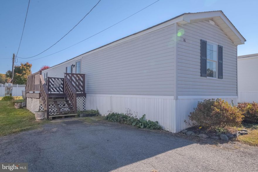 Welcome to 18 Saint Michaels Court in Elkton, MD! This charming 3-bedroom, 2-bathroom singlewide manufactured home offers a perfect blend of modern style and comfort. With beautiful laminate flooring throughout, the home is move-in ready and filled with natural light, thanks to the open-concept living room and kitchen. The kitchen includes a convenient breakfast bar, plenty of storage and a gas range. When you proceed into the hallway, enjoy the convenience of main floor laundry.

Outside, private parking right in front, as well as a cozy front porch AND a relaxing patio—ideal spots for unwinding after a long day. As a bonus, the sellers are including a 70-inch flat-screen TV with the home!

A list of all appliances and recent updates is available in the documents section. Don’t miss out on this opportunity to own a stylish, comfortable home in a great location! Schedule your showing today!