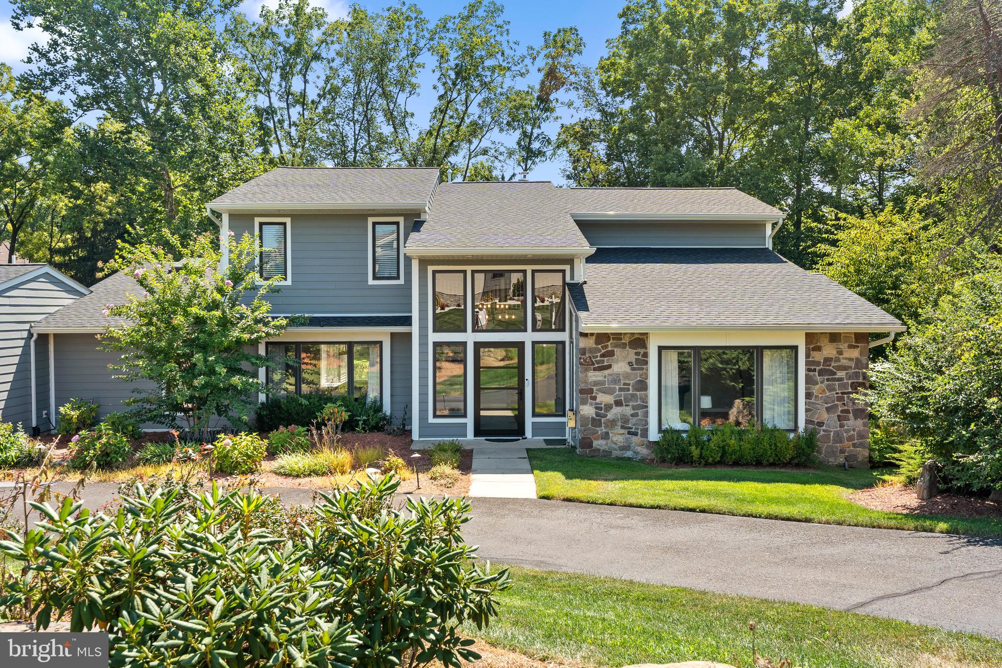 Come see this stunning contemporary home designed for multi-generational living—a rare and highly desirable find. Ideal for those seeking their own space and privacy, while enjoying shared family areas. This renovated property features 5 bedrooms, 5 full bathrooms, and 2 half bathrooms, including two main bedroom suites on the first floor and 3 bedrooms with private baths on the second floor.
Step into a sleek, modern design with an open floor plan bathed in natural light. Enjoy new, durable engineered floors, a two-story foyer, and inviting living and dining areas. The gourmet kitchen features an oversized island, stainless steel appliances, and a walk-in pantry that doubles as an office. Relax in the spacious family room with a fireplace, or unwind in the sunroom overlooking the paver patio.