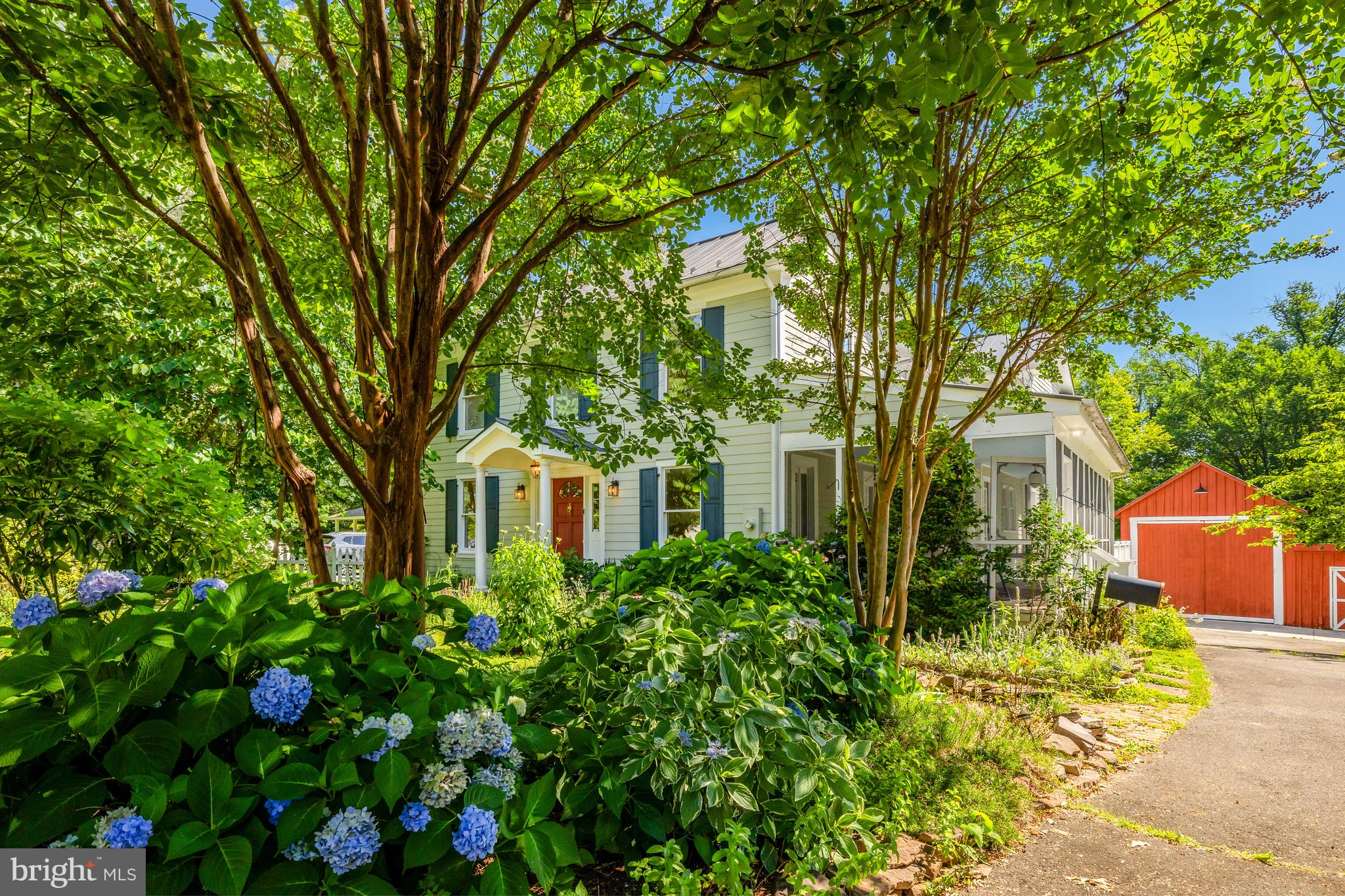 OPEN HOUSE Sat (Aug 2) and Sun (Aug 3) 2-4pm
A Rare Gem in Historic Downtown Herndon – 1904 Charm Meets Modern Luxury
Homes like this don’t come up for sale often—this is your opportunity to own a truly special piece of Downtown Herndon history. Built in 1904 and lovingly expanded and updated over the years, this home blends timeless character with thoughtful modern amenities.
From the moment you arrive, the curb appeal delights—a classic white picket fence, vibrant organic gardens, and mature plantings including peonies, persimmon, blueberries, raspberries, apple and cherry trees. Every inch of the landscaping has been curated with care, offering a calming, nature-filled escape just blocks from the heart of town.
Step inside and be instantly drawn through the original home, the thoughtfully designed addition, and out into the lush backyard. The living room is bright and inviting, featuring original hardwood floors, elegant moldings, and French doors that open to a tranquil screened porch—just one of three incredible outdoor living spaces.
The dining room is ideal for entertaining, filled with sunlight and rich with period charm. And then there’s the kitchen: a chef’s dream! Fully renovated with marble countertops, premium stainless appliances, two oversized farmhouse sinks, and luxurious custom Smallbone cabinetry. The expansive island offers endless prep space and seating, and the adjoining breakfast nook is a wonderful spot for morning coffee.
A three-level addition, completed around 2000, brings even more space and flexibility. On the main level, you’ll find a stunning 31' x 13' family room with in-floor heating, a full bathroom, and potential for a main-level primary or guest suite. French doors lead to a serene flagstone patio shaded by an English rose-covered pergola—perfect for outdoor dining or a spot to peruse Instagram.
Head upstairs via your choice of two staircases, including a tucked-away set off the kitchen. The primary suite is spacious and serene, featuring garden views, ample closet space, and a spa-like bath with heated floors, a jetted tub, and a walk-in, door-free shower with multiple shower heads. An attached room—originally the primary bedroom—offers versatility- a quiet home office? Sitting room? A HUGE closet? or a 4th bedroom!
Two additional upstairs bedrooms also feature gorgeous original hardwood floors and share a third full bathroom in the hall.
Need space for hobbies, work, or adventure? The large barn was originally built to house an RV! The workshop was originally a 2 car garage... both spaces offer exceptional flexibility. Whether you’re into woodworking, art, or just need a space to retreat and enjoy the sound of rain on the metal roof, you’ll love it here.
All of this, just blocks from Herndon’s vibrant downtown: restaurants, shops, Herndon Library, Dairy Queen, Great Harvest Bread, Friday Night Live summer concerts, Tuesday concerts at the old Town Hall, a farmers market on Thursdays, W&OD trail, Wintermarkt and more! Enjoy easy access to the Metro Silver Line- three stops are nearby, Dulles Airport, Reston Town Center, and miles of nearby parks and trails.
With Town of Herndon services including trash pickup, recycling, snow and leaf removal, and community police and public works—you’ll feel completely spoiled living here.
This is more than a home. It’s a lifestyle. Welcome to Downtown Herndon. Welcome home.