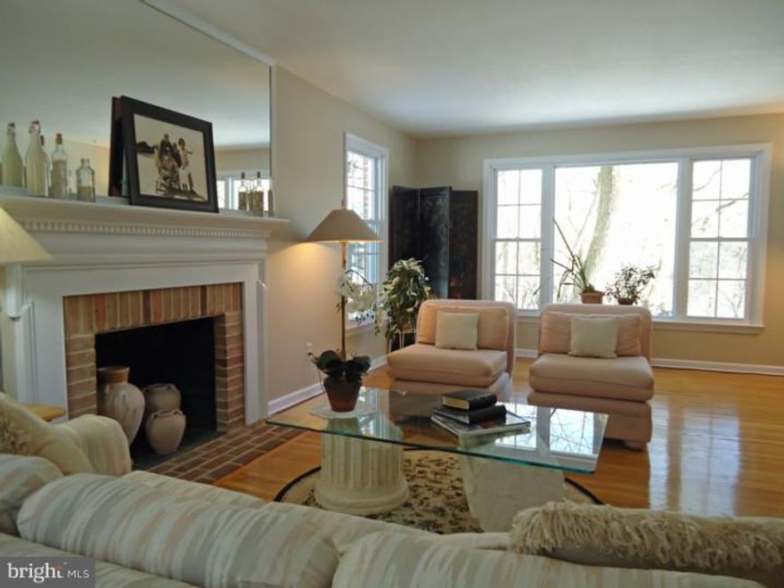 This meticulously maintained brick Colonial home has privacy and scenic views yet has quick access to Gladwyne Village, schools and a short walk to Saunders Woods.  It is sited on almost 1.6 acres with a stream, private woods, a side yard with room for a pool or game of badminton and an allee of beautiful cherry trees lining Norsam Road you can enjoy from the tiered front patio.  The spacious living room with fireplace and dining room are wonderful for family celebrations.  The new country kitchen with its beamed ceiling, brick barbecue and French doors to the new back deck are perfect for more casual entertaining. There is even room for a hot tub off the deck.  The sunny family room is cozy yet sunny and spacious with its brick fireplace and flanking window seats. The generous second floor has five bedrooms and three full bathrooms.  The two largest bedrooms (one with fireplace) have private bathrooms so you can choose which will be the master suite and use the other for guests, in-laws or an au pair.  The owners have made numerous improvements including a new roof, garage doors, a new kitchen with stainless steel appliances, new deck, new windows and updated furnace and air conditioning.  When you must leave home, Center City, King of Prussia and the train are an easy commute.