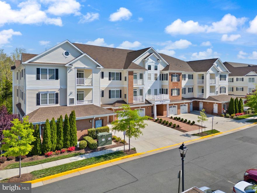 Welcome to this stunning Oakhill floorpan in Regency at Dominion Valley. This third-floor condo is the kind of place that instantly makes you feel at home—and honestly, it’s rare to find something that checks this many boxes. Tucked away at the end of the building with serene, wooded views out back, this unit offers privacy, quiet, and the kind of peaceful setting you’ll love waking up to every day. Whether you’re sipping coffee on the balcony or winding down at the end of the day, the backdrop of trees makes it feel like your own little retreat.

Inside, everything feels light, bright, and thoughtfully designed. Beautiful engineered hardwood floors run throughout the main living areas and kitchen, adding warmth and elegance and easy maintenance. Plantation shutters frame each window, giving the space a tailored look while also letting in just the right amount of natural light. The open layout makes entertaining easy, with the kitchen flowing into the living and dining areas—perfect for everything from quiet evenings to hosting a few friends.

Both bedrooms are filled with sunshine, and the primary suite is a total standout. You’ll find not one, but two closets, plus a spacious en suite bathroom that feels like a private escape. A full-size washer and dryer are tucked away for convenience, and every inch of this home has been cared for and loved since it was built in 2017.

And the perks don’t stop inside. This home includes a private one-car garage with room for a second car in the driveway—something that’s not always easy to find in a condo. It’s all part of the lifestyle that comes with living in Regency at Dominion Valley, a gated 55+ community where life just feels easier. Think: beautifully maintained grounds, walking trails, a clubhouse, indoor and outdoor pools, tennis courts, and golf just around the corner. Everything is close, but it never feels crowded. It’s quiet, welcoming, and social—exactly what so many people are looking for when they’re ready to slow down just a bit without sacrificing convenience or connection.

This isn’t just a place to live. It’s a place to *love* where you live. Ready to see it in person? You’re going to fall head over heels.