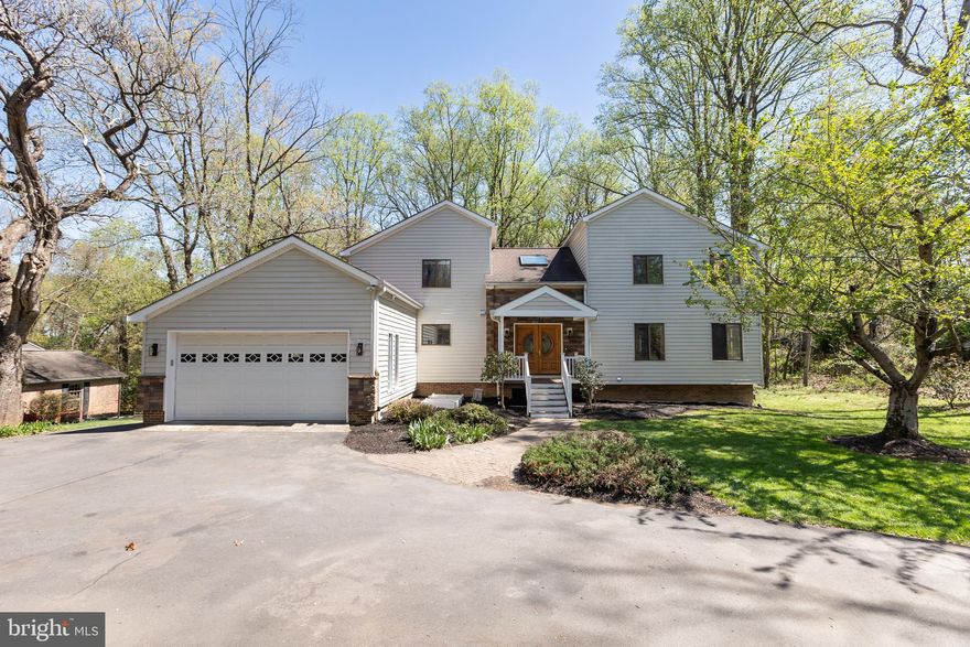 A rare jewel nestled in the heart of Great Falls. This unique contemporary home offers a sophisticated blend of luxurious living, entertainment, and a tranquil, nature-focused environment. The residence features five exceptionally spacious bedrooms and 4.5 bathrooms. The main floor is designed with an open, light-filled layout, including a living and dining area with high ceilings and direct access to both a sunroom and a deck. The kitchen is a standout feature, finished with vibrant red cabinets, white quartz countertops, and a new range and refrigerator. An ACCESSORY KITCHEN provides additional prep space. The MAIN-LEVEL MASTER SUITE serves as a private retreat with a NEWLY RENOVATED BATHROOM featuring a soaking tub, separate shower, and dual vanity. A second bedroom on the main level offers versatile options for use as a home office or a guest room. On the upper level, you will find a THIRD BEDROOM WITH AN EN-SUITE BATH, a fourth bedroom, and an additional full bath. A KEY HIGHLIGHT OF THE UPPER LEVEL IS THE EXPANSIVE FAMILY RECREATION ROOM, ideal for hosting gatherings. The lower level is equally impressive, featuring a fifth bedroom, a full bath, and an OVERSIZED STATE-OF-THE-ART HOME THEATER equipped with a large screen, surround sound, and nine reclining sofas. The property's exterior is ideal for nature lovers, featuring cherry trees, grapevines, and various fruit trees. For recreation and entertaining, the grounds include a basketball court and a deck with a dedicated gas line hook-up for summer cookouts. A spacious two-car garage provides ample storage and vehicle space. The property has significant RENOVATIONS AND UPGRADES. 2026: NEW MASTER BATHROOM, ENTIRE HOUSE FRESHLY PAINTED, NEW OR REFINISHED HARDWOOD FLOORS, NEW REFRIGERATOR (MAIN KITCHEN), and full lot landscaping. 2021 & 2025: two 50-Gallon water heaters. 2025: well pump.  2024: New heat pump compressor (lower level). 2011–2012: Roof (50-year warranty), all sidings (Thompson Creek, lifetime warranty), garage door, main kitchen and appliances, accessory kitchen and appliances, and bathrooms, and one of the septic tanks rebuilt. For more details, please refer to the list of renovations and upgrades. The property is under video surveillance.