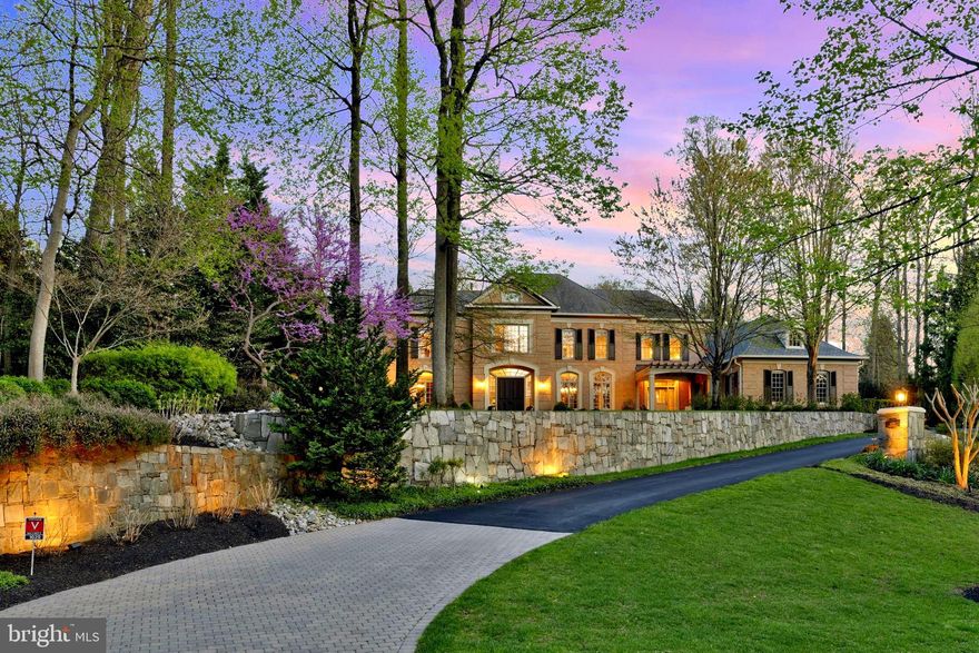 Your search is over..this custom-built, all brick, Gulick home is a private, true sanctuary on over an acre. This exceptional, fenced, backyard is designed for ultimate relaxation and entertainment. Designed with an abundance of stone hardscaping and floral blooms every month of the Spring/Summer/Autumn.
A resort-style pool with a cascading waterfall and heated spa, an outdoor kitchen, and expansive patios with a built-in fire pit create the perfect setting for unforgettable gatherings. This gorgeous home spans close to 8,000 square feet offering a rare balance of space, design, and functionality. Step inside to discover a home filled with exquisite architectural details. Natural light pours through oversized windows, accentuating the soaring ceilings and thoughtful layout. The main level, open floorplan, is designed for everyday living and entertaining whether it’s hosting in the Dining Room or unwinding in the Family Room or the cozy Hearth Room accented with a striking stone fireplace.  The inviting foyer leads to the elegant Living Room, seamlessly flowing into the sophisticated Dining Room. The gourmet Kitchen is a chef’s dream with a large center island with seating, two sinks and ample cabinetry. A well-equipped family foyer that leads to the 3 car garage, features a mudroom including custom built-ins, a walk-in pantry, a second powder room and laundry room. On the main level, you'll also find a beautiful Library/Office with custom built bookcases. Upstairs, the luxurious Owner’s Suite is a private retreat, highlighted by a separate sitting room, custom walk-in closets, and a spa-inspired bath with dual vanities, oversized shower and separate jacuzzi tub. To complete the upper level, there are 3 additional Bedrooms with en- suite baths and walk-in closets. The lower level is an entertainer’s paradise, featuring a custom recreation room, a Fitness Room, billiards room, and an additional Bedroom and Pool Bath.  Located in the Langley High School, Cooper Middle School and Spring Hill Elementary pyramid, this home offers exceptional privacy without sacrificing convenience, all within one of McLeans’ most sought-after communities.