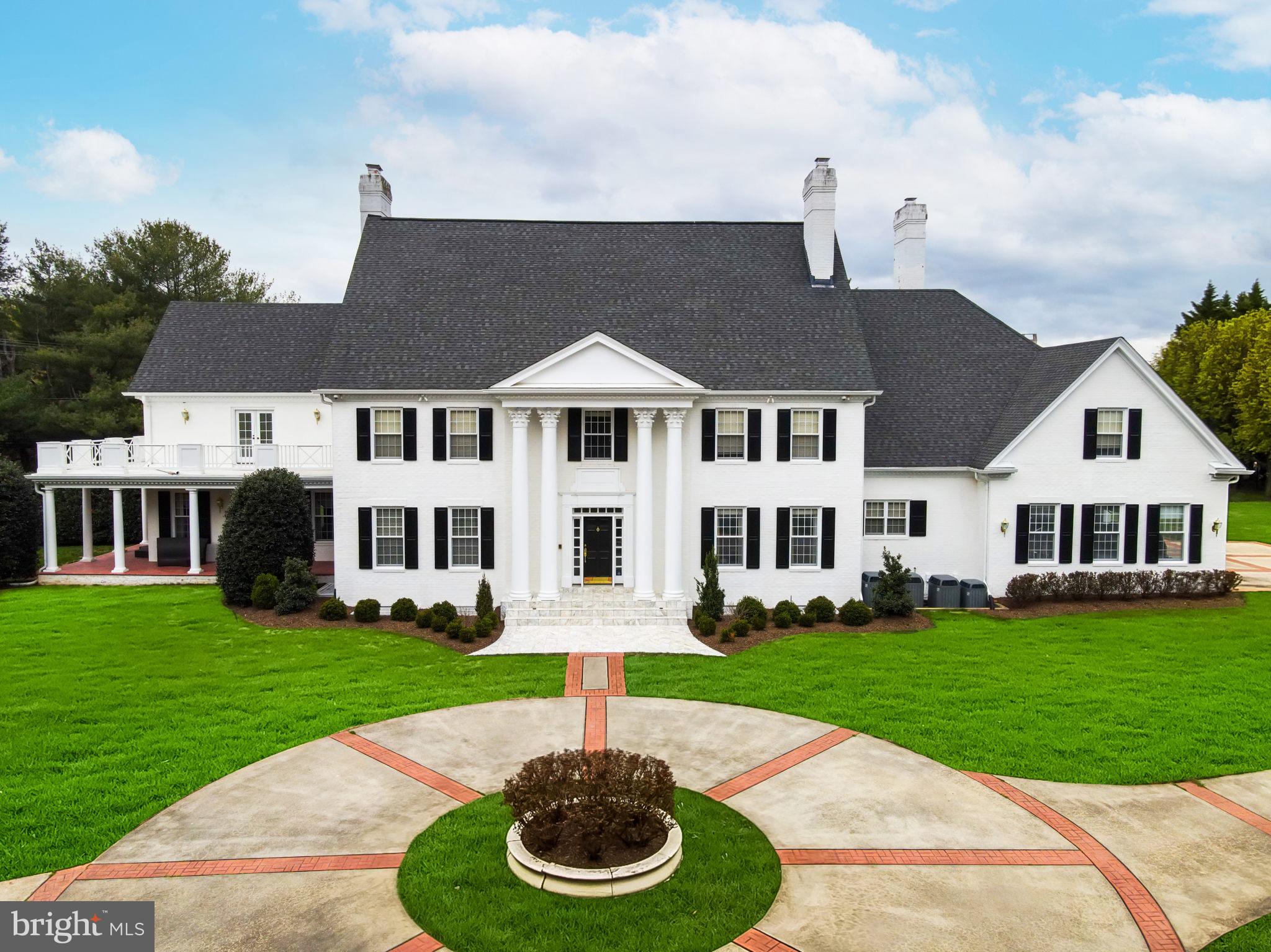 An updated private estate in the heart of Potomac’s. Built by award-winning Crowell and Baker, this custom colonial compound is the architectural masterpiece you’ve been dreaming of. Step into the
elegant two-story marble foyer adorned with matching Schonbek crystal chandeliers, intricate millwork and 270-degree gallery views. Natural light streams in through the oversized windows and doors with east/west exposure and the 10 foot ceilings emphasize the unprecedented grandeur of this home. Rich hardwood floors in a herringbone pattern provide the perfect base for traditional or modern décor in the main living areas of this meticulously maintained abode. Designed for both formal entertaining and casual living, the opulent formal dining room, family room and formal living room all feature wood-burning
fireplaces surrounded by marble, ornate moldings and custom built-in shelving. The family
room offers a wet bar with outdoor views and access. Walk down the hall through the French doors to the private wood-paneled library with views of the beautifully landscaped grounds. The expansive kitchen was updated in 2021 It has a walk-in pantry and a butler’s pantry with second dishwasher. The adjoining breakfast room with Schonbek crystal chandelier, wood-burning fireplace, built-ins and backyard access offers a modern complement to the stately home. Two marble powder rooms, a mudroom and concealed laundry room complete the main level. Take either of the two staircases to the thoughtfully designed upper level which showcases two primary suites. The largest primary bedroom has balcony access, a fireplace and three large walk-in closets. The chic en-suite bathroom was completely renovated in 2022 with dual vanities, sizeable glass shower, soaking tub. The second primary bedroom/in-law suite has a sitting room, spacious walk-in closet and en-suite bath with dual vanities. Scenic views and sunlight pour in through the windows of the four generously sized secondary bedrooms. On the lower level, the open floor plan offers a full footprint consisting of recreation space, a dedicated fitness area, wet bar, wine cellar, sauna, room with full bath and ample storage space. The raised basement affords plenty of natural light. Your outdoor oasis is the perfect place to unwind by the heated pool with automatic cover. You can entertain in the pool house with wet bar and full bath or under one of the backyard pergolas. Extensive landscaping, patios and walkways ensure this is an outdoor space everyone will love. Ideal 2 acre property situated on a flat corner lot with circular driveway, 3 car side load garage and secure gated entry. Less than 1 mile to Potomac Village shops, restaurants and grocers. Easy access to DC, I-495, 270 and 95.