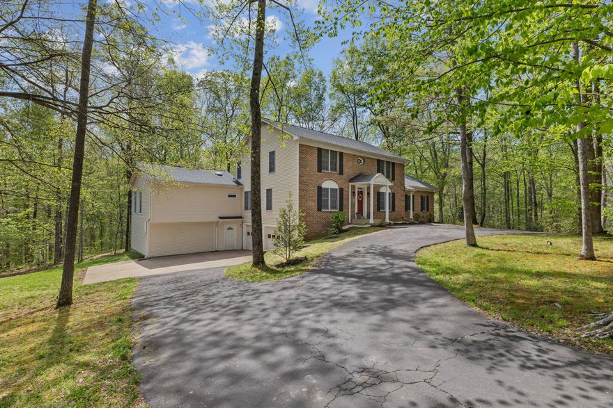 Tucked away at the end of a quiet cul-de-sac on over two wooded acres, this one-of-a-kind property offers a rare sense of privacy, natural light, and a true retreat-like setting.

A dramatic double-height foyer opens to a light-filled interior, where 16 skylights and expansive windows frame peaceful wooded views and a natural stream on the property.

Hardwood flooring extends throughout the main living areas, stairs, bedrooms, and recreation room. The updated kitchen features quartz countertops, a tiled backsplash, and a spacious walk-in pantry, designed for both everyday living and effortless entertaining.

Multiple sun-filled living spaces, a wood-burning fireplace, and two expansive decks create a seamless connection between indoor comfort and the surrounding landscape.

A true standout, the enclosed, climate-controlled pool retreat features a heated infinity lap pool for year-round enjoyment, a full bathroom, and walls of windows that bring the outdoors in.

The home offers 4 bedrooms and 4.5 bathrooms, including a spacious primary suite with a walk-in closet and a skylit bath designed for comfort and relaxation.

Additional highlights include a dedicated home office with wooded views, a versatile recreation or bonus room with a separate entrance, two finished lower-level rooms with an adjoining full bathroom, a large 2-car garage, updated HVAC systems, a newer water softener, and an updated well.

No HOA. Ideally located near commuter routes, shopping, dining, and Colgan High School.