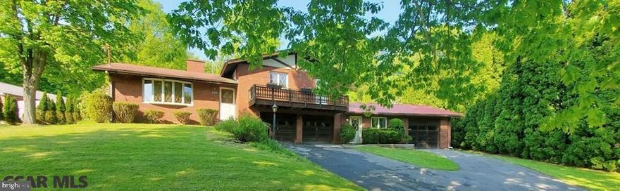 This well built, 4 BEDROOM split-level home, has just been listed for sale. Don't miss your chance on this solid brick home, that has not 1 or 2, but 3 attached GARAGES! Classic hardwood floors on the upper level, while downstairs there is so much potential for you dream kitchen! Fresh paint/updating could help bring in more light & make it pop with a more modern look. Located behind the Lock Haven Hospital on a quiet neighborhood road within biking distance of the University. Breathtaking lot with .76 acres with beautiful fruit trees out in the backyard, where the property line adjoins a secluded/wooded area of roughly 70 acres. Home includes 1 full bath, 2 half baths, a large workshop area, 2 fireplaces, a wood burning stove, and a charming balcony out front.