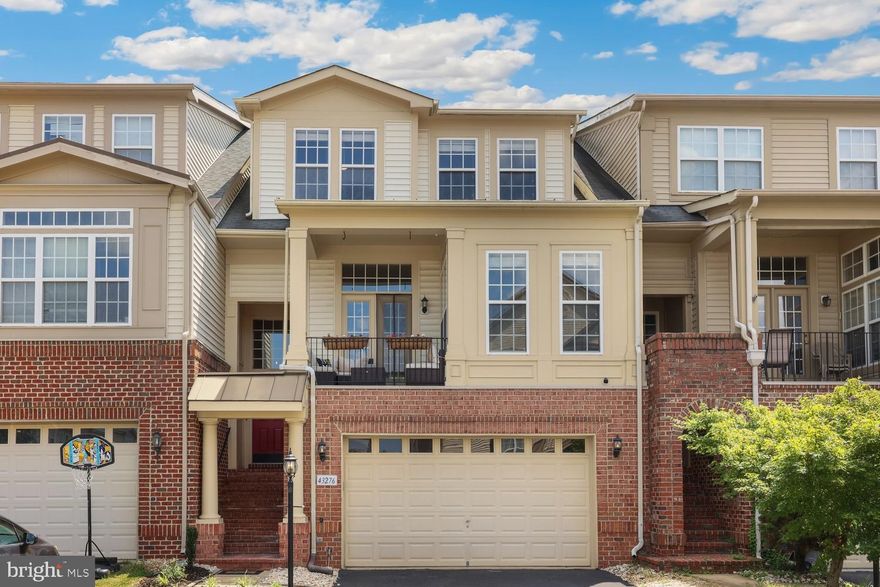 Welcome to this beautifully appointed townhome in the heart of Ashburn's sought-after Broadlands neighborhood, where thoughtful design, modern comfort, and natural beauty come together.


Nestled in a scenic and well-maintained community, this brick-front home offers 4 bedrooms and 3.5 bathrooms across a smartly designed floorplan. Soaring 10-foot ceilings on the main level create an open, airy ambiance, complemented by abundant natural light and gleaming hardwood floors. The open-concept layout features a flexible living and dining area, a bright loft, and a separate home office—ideal for both everyday living and work-from-home needs.


The kitchen includes a large pantry and generous storage throughout, including clever under-stair storage. Tucked behind a custom Murphy door bookshelf, a secret game or reading room offers a fun surprise. Upstairs, the primary suite is a peaceful retreat with a walk-in closet, soaking tub, and private balcony. A convenient laundry room is located on the bedroom level for everyday ease.


Completing the interior is a spacious walkout basement with a full bath, large living area, bonus bedroom, and additional storage—perfect for guests, entertaining, or extended living.


Enjoy outdoor living with three separate balconies—front, rear, and off the primary suite—ideal for morning coffee or evening relaxation. The home backs to a protected nature preserve, offering serene green views and added privacy, and a covered patio off the basement extends the outdoor space even further.


Located within a top-rated school district and just moments from community pools, parks, playgrounds, and scenic trails. Enjoy easy trail access to a nearby shopping center with restaurants, a grocery store, and coffee shop. Commuters will appreciate the proximity to Metro rail stations and major roadways for seamless travel throughout Northern Virginia and into D.C. Don't miss your chance to make this home yours, book your tour today!