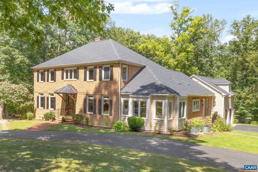 This stately brick home offers both convenience and privacy on over 4 acres, just minutes to downtown, UVA, Barracks Road, Shops at Stonefield, and the airport. Gracious spaces include a gourmet kitchen, formal dining room, sunroom, living room with fireplace, and multiple home office/study options. With two primary suites (including one on the main level), total of 6 bedrooms, and a versatile walk-out lower level with rec room, bedroom, full bath, and office, the layout adapts to many needs. Outdoor living shines with a deck, and extensive hardscaping (2018). Thoughtful updates include new roof (2024), resurfaced driveway (2023), and energy-efficient geothermal system. Additional highlights: side-load garage, circular drive, central vac, well irrigation system, and whole-house generator. A rare combination of location, space, and upgrades.,Granite Counter,White Cabinets,Fireplace in Family Room,Fireplace in Living Room