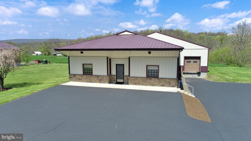 Are you ready to start or expand your business? This well-maintained Morton building is just 30 minutes from State College and 20 minutes from Huntingdon. Inside you will find the main warehouse space with a loading dock and 12 foot ceilings, two bathrooms, and a bright front office space to include a private office. In the back is a separate storage space with a drive in garage door. Each unit has its own 150 amp electric meter.  Outside is a large paved parking area with yard space behind and beside the building.  There is no zoning in this township, offering a myriad of opportunities at an affordable price.  Parcel 25-06-08.9 is included. Total acreage is 1.81. Agent is one of the owners.