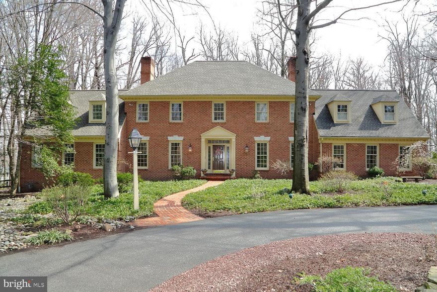 This stately all brick Getz's Woods home has a circular driveway entrance leading to a perfect private setting.  The home features a beautiful spacious updated kitchen w/ stainless steel appliances, a large island and breakfast room.  The living room, family room, and dining room all have fireplaces.  There is a 1st floor study plus an additional room that could be used for a 2nd study or 1st floor bedroom complete with full bath and walk-in closet.  The stunning curved staircase leads to the 2nd floor and a fantastic master suite and 3 additional bedrooms.  A separate staircase leads to a private  nanny/in law quarters with a full bath.  The finished basement has a kitchenette and half bath.  The large wrap around deck in this private setting in perfect for entertaining.  There is a 3 car garage a new roof, gas heat, lots of hardwood flooring and so much more.  This home is not to be missed  Reserved item are the wine racks in the basement.
