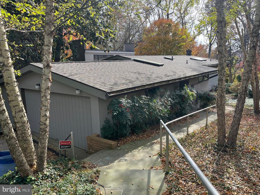 Nature lovers dream in close in Bethesda. 1.4 acre lot in Tulip Hill with spectacular views and limitless potential. Renovate or tear down, but home is in good condition and perfectly livable as is. 
The main level, with elevated ceilings, features the primary bedroom with en suite bathroom and walk in closet, second bedroom/office, eat in kitchen, and a large living room with wooden cathedral ceilings. The back of this level accesses a large deck with sweeping views.
The lower level walks out the the peaceful terrace, side yard and a deep wooded area, stretching all the way to MacArthur Blvd. This level features 3 bedrooms, 2 bathrooms a rec room, laundry and storage/utilities/workshop.
Incredible opportunity in Tulip Hill, Ideally located in one of Bethesda's most desirable neighborhoods - just minutes from Downtown Bethesda, Washington DC, Northern Virginia and the C & O Canal Trail.
Tulip Hill is an amazing community of broad boulevards, neighborhood dog walks, and Front-Yard-Fridays.