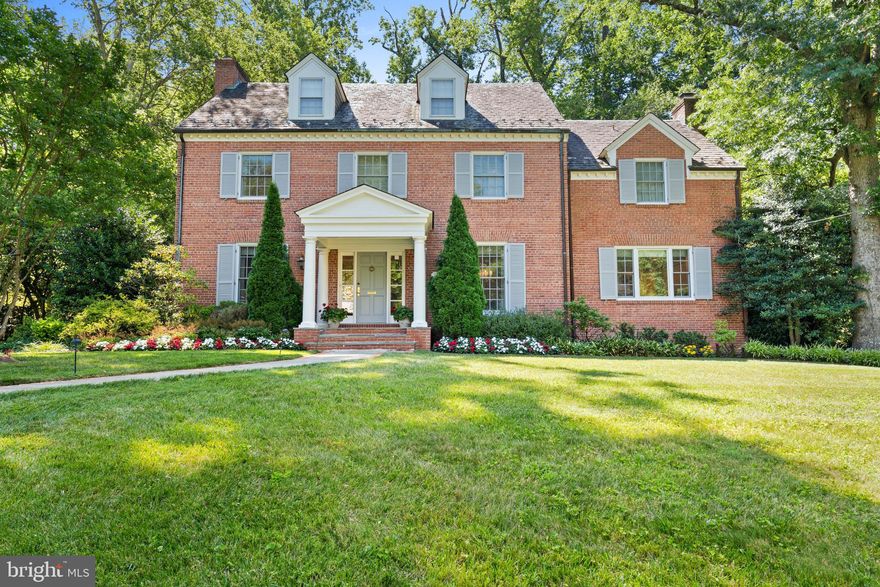 This gracious brick residence is well-sited on the .46-acre corner lot in the sought-after neighborhood of Kent. The house has been beautifully updated and expanded under the discerning eye of Kelley Proxmire. It offers a seamless integration of indoor and outdoor living spaces, ideal for both relaxation and entertaining. The welcoming foyer, accented with sophisticated wall paneling, gracefully transitions into the living and dining rooms. The living room features a lovely fireplace, large windows, and French doors that open to the rear, all adorned with dentil moldings for added elegance. Adjacent, the dining room includes built-in shelving and cabinetry, further enhanced by a large window and matching moldings. The family room or library is a versatile space with a wood-burning fireplace, intricate moldings, and built-in shelving, complete with French doors that open to a charming screened porch. This porch is fully windowed, offering panoramic views of the lush garden and green surroundings. The updated chef’s kitchen is well-appointed with a large center island, double wall ovens, a full-sized Sub-Zero fridge and freezer, and abundant cabinetry. It opens to the sunlit breakfast room, which features a soaring Cathedral ceiling and a wall of windows, plus two sets of French doors—one leading to the exterior and another to the inviting sunroom. There is also the added convenience of a powder room and coat closet on this floor. Upstairs, the primary suite serves as a luxurious retreat with multiple walk-in closets, built-ins, and a recently renovated spa-inspired en-suite bathroom that includes dual vanities, a large soaking tub, a frameless glass shower with multiple water features, and a linen closet. The second floor also hosts an oversized bedroom with a soaring ceiling and two additional bedrooms, each thoughtfully designed with ample closet space, and one featuring an en-suite bathroom. A well-appointed office with wooden built-in shelving and cabinetry completes this floor. The third level offers flexible space, ideal as a bedroom or hangout area, equipped with built-ins, window seats, a skylight, and ample storage. Another bedroom and a full bathroom complete this level, adding to the home’s functionality and charm. The lower level includes a recreation room with a built-in media cabinet, a wood fireplace, and ample storage space, alongside a a bedroom, full bathroom, a laundry room with extensive cabinetry and a utility sink, and a workshop with a secondary fridge. The oversized two-car garage, accessed from the lower level, offers additional storage space and exterior access. Outside, the exterior of the home is exceptionally private, complemented by a rear brick terrace with multiple seating areas set against a backdrop of mature trees. There is a flat pool-sized rear yard surrounded by beautifully landscaped gardens. This wonderful offering is within walking distance to neighborhood favorite restaurants, shops, and parks.