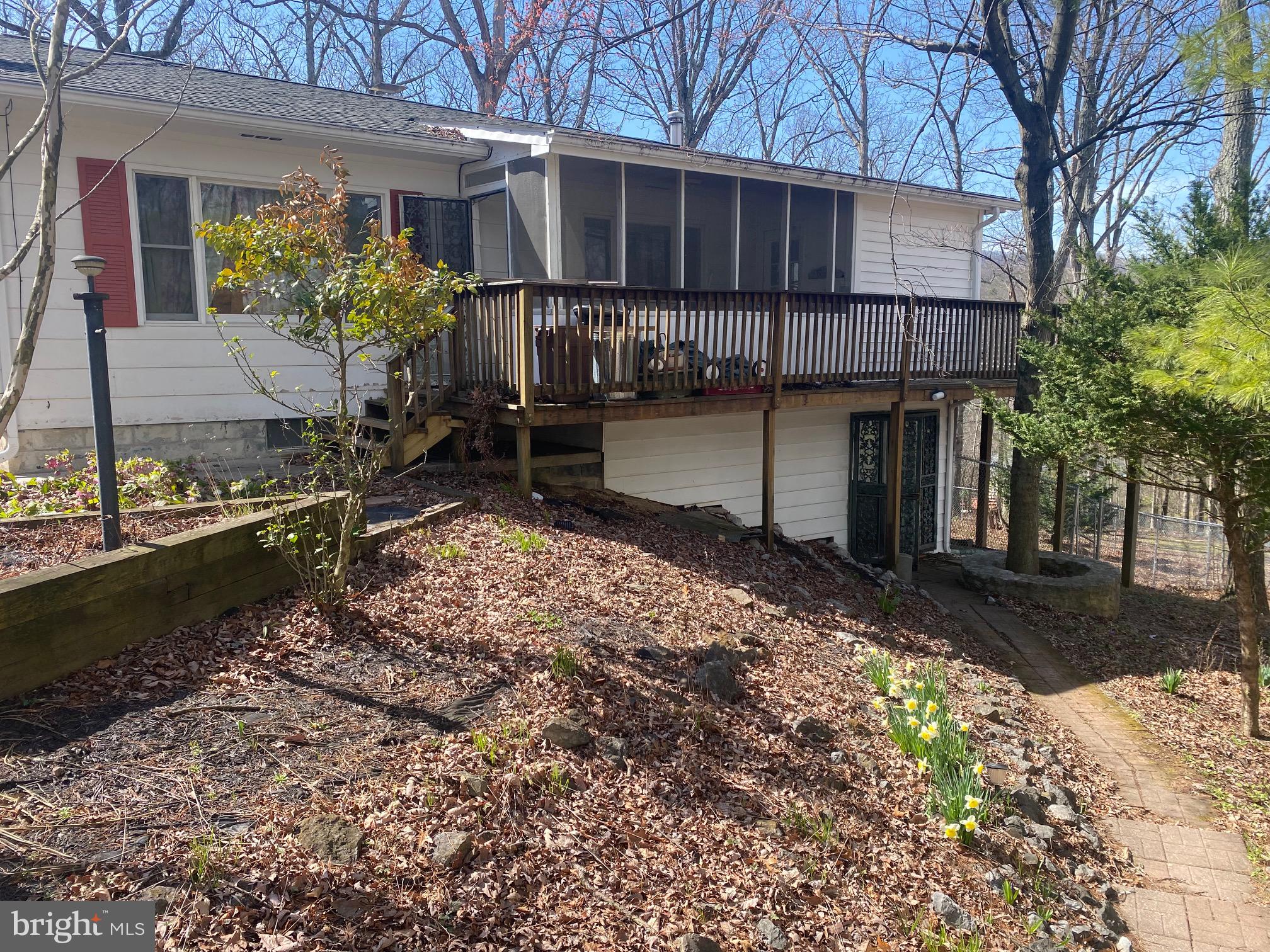This 2 bedroom lower-level unit features lots of living space. It features a spacious sunroom with tons of windows. The living room includes a woodburning fireplace. This keeps with space nice and cozy! The kitchen is fully equipped with refrigerator, microwave, and stove. You'll have oak cabinetry with laminate countertops and easy care vinyl floors. Bedroom 1 features carpet and a ceiling fan. Bedroom 2 includes hardwood floors. Hall bath is outfitted with a 3 ft acrylic shower, single bowl vanity, and easy-care laminate floors. This home is nestled in the beautiful mountains of Hedgesville, WV. You'll have lovely mountain views in addition to the other amenities. Call for more information today!