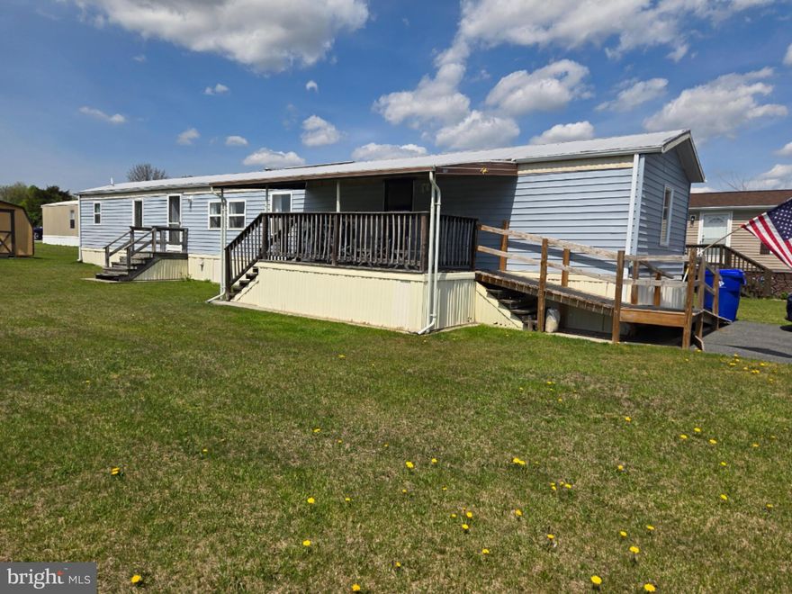 Just like new! This beautifully renovated mobile home feels fresh and welcoming from the moment you walk in. You’ll love the open floor plan and the functional kitchen, complete with an oven/range, refrigerator, new cabinets, an island with a full sink and dishwasher, a cozy eating area, and a large pantry. Luxury vinyl flooring runs throughout the home, and the mini-split system provides multi-zone A/C for added comfort. There are 2 spacious bedrooms and 2 full baths, The primary suite has a full bath and walk-in closet. The primary bath features a rainwater shower and a new vanity for a modern touch. There is also a bonus area idea for an office, craft area or anything you need additional space for. There is a laundry area which includes a stackable washer and dryer. Some of the unseen features are the tankless hot water heater, insulated pipes and walls and all the care that went into this property.
Outside, you’ll find new siding, a new ramp, and a storage shed for all your extras. This is a wonderful opportunity to own a fully updated home with modern touches and plenty of charm! Please note that buyer park approval is required.