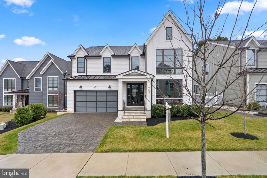 Welcome to your dream home! This exquisitely crafted and beautifully designed modern home by Classic Cottages is nestled among nine residences on a quiet cul-de-sac with an array of luxury features and high-end finishes, creating an unparalleled sanctuary for comfortable and spacious living.

As you step inside, you'll be greeted by an inviting open floor plan featuring high ceilings, beautiful hardwood floors, and an abundance of natural light pouring through expansive windows, creating a luminous and welcoming atmosphere. With Hunter Douglas custom roller shades adorning 22 windows and doors, complemented by convenient light dimmers, setting the perfect ambiance is effortlessly achieved.

The heart of the home, the expansive kitchen island, adorned with stunning Quartzite countertops, along with the wet bar and top-of-the-line Sub Zero Wolf appliances, caters to both culinary enthusiasts and entertainers alike. Adjacent to the kitchen, the spacious family room offers panoramic views of the backyard and showcases a striking Eldorado Stone Xtrordinair Probuilder 72 linear fireplace, infusing the space with an aura of sophistication. Completing the main level is a formal dining room, ideal for hosting gatherings, an in-law/guest suite/home office, a convenient mudroom, and a 2-car garage with bonus ceiling storage.

Upstairs, the indulgent owner's suite awaits, alongside generously sized bedrooms. Pamper yourself in the spa-like ensuite bathroom with dual walk-in closets providing ample storage space.

The walk-out lower level extends the living space, offering a sizable rec room, a built-in bar, and a fully equipped home gym. Outdoor living is equally delightful, with a fenced yard, patio, and irrigation system for lush landscaping.

Conveniently situated near Westover with access to top-rated schools, commuting is a breeze with VA-66 and East Falls Church metro nearby. Explore nearby walking and bike trails or take advantage of the plethora of amenities in close proximity, making this home the ultimate retreat for modern living.