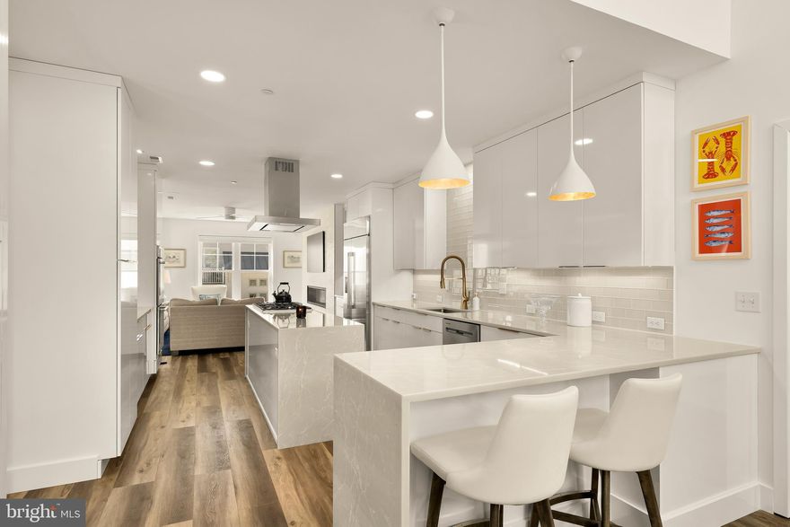 Welcome home to 38851 Grant Ave — a stunning canal-front masterpiece moments from Delaware's most scenic beaches near Fenwick Island. While others wait on permits, punch lists, and construction timelines, this move-in ready coastal gem is available right now. No waiting. No dust. No delays. Just pure, polished waterfront living — with a private dock, deep-water access to the Assawoman Bay, and a maritime lifestyle starting day one. This exceptional seven-bedroom + den, three full and two half-bathroom residence spans nearly 4,500 square feet across four thoughtfully designed floors. Only four years young, it lives and feels brand new — without the often overlooked new construction upgrades like custom closets and $12,000 worth of custom window coverings that are already installed in this home. An inverted floor plan maximizes views at every turn. Take the elevator to the third floor and prepare to have your breath stolen — a bespoke, magazine-worthy designer kitchen anchors the living and dining spaces, featuring Crystal cabinetry, quartz surfaces, a Thermador and GE Monogram appliance package, and clever kick-toe drawers that keep everything effortlessly organized. Just past the kitchen, a custom built-in bar commands attention: leathered marble, custom millwork, and a curated Marvel chiller suite — mini fridge, 100-bottle wine fridge, and a continuous ice maker — because your guests deserve better than lukewarm rosé. These spaces flow seamlessly to a large screened and covered porch with custom vinyl inserts for year-round use, ceiling fans, and sweeping canal views that make every evening feel like a getaway. The primary suite occupies its own wing on this level, offering an oversized bedroom, custom walk-in closet, designer bath, and sliding glass doors opening to a private canal-view deck. A linear fireplace anchors the living room, with a private office and powder room tucked neatly around the corner. The second floor hosts four secondary bedrooms, two full baths, a den perfect for an office, and a generous outdoor deck. The top floor flex space — ideal as a seventh bedroom or bonus room — opens to a rooftop deck with breathtaking bay views. On the ground floor, an insulated two-car garage with game room space rounds out one of the most versatile floor plans on the Delaware coast. Outside you will find a lush, but manageable, yard, large covered patio space, outdoor shower and a dock that has electricity – perfect for sunbathing or watersports – providing access to the deep waters of Assawoman Bay. Built with structural substance to match its style: 47 pilings, a four-story fire suppression sprinkler system, maintenance-free siding, composite decking, and VertiCable railings — structural details that protect your investment for decades. Minutes from Fenwick Island State Park, world-class dining, boutique shopping, and the beloved Freeman Stage outdoor concert venue. The Cape Windsor community adds a pool, tot lot, and picnic area. This is Coastal Delaware living at its absolute finest. Call it yours today — no waiting required.