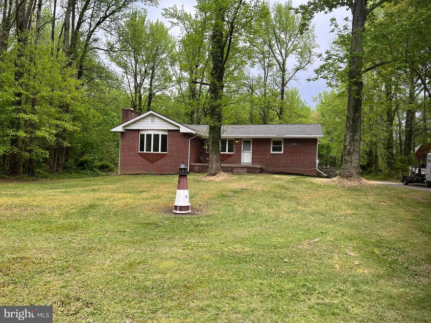 Level 3.3 acres, mostly clear with some woods. Updates through out including: Roof, kitchen cabinets, counters, and appliances. LVP flooring through out. Fresh paint. Masonry fireplace in large family room. Very convenient location. 2 miles to I95. Quiet and private with plenty of wildlife. Updated light fixtures, outlets and switches. Hook up for portable generator. Wrap around paved driveway. Call for appointment. Updated heat and A/C. 2148 sq ft above grade.
